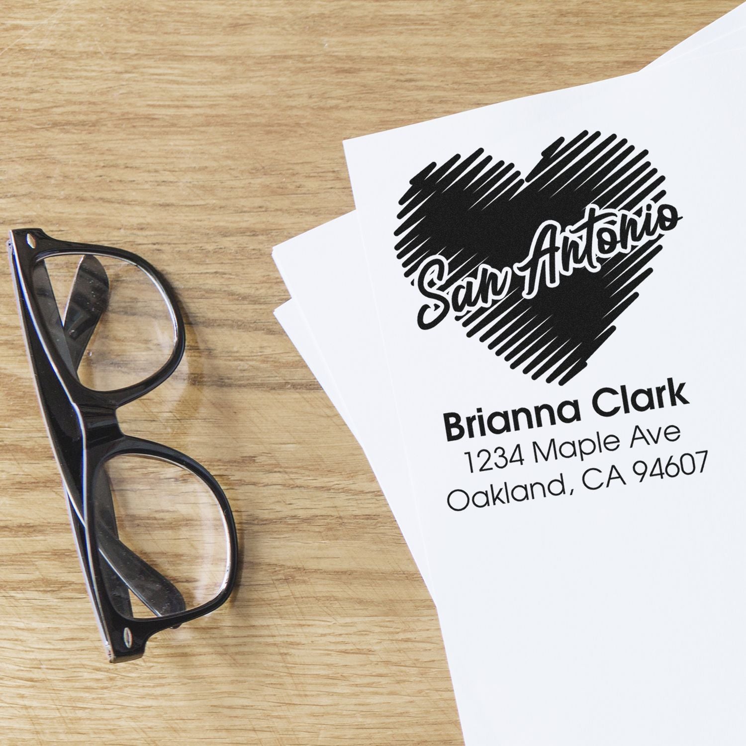 Personalized rubber address stamp with heart logo and name for custom mailing labels and stationery.