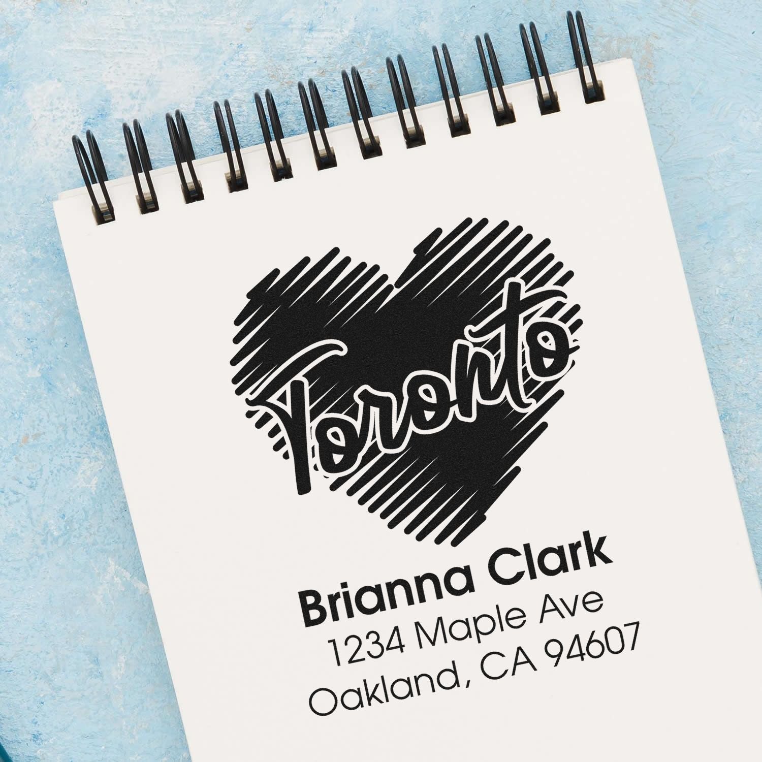 Custom address rubber stamp with heart design for Brianna Clark, Oakland, CA 94607