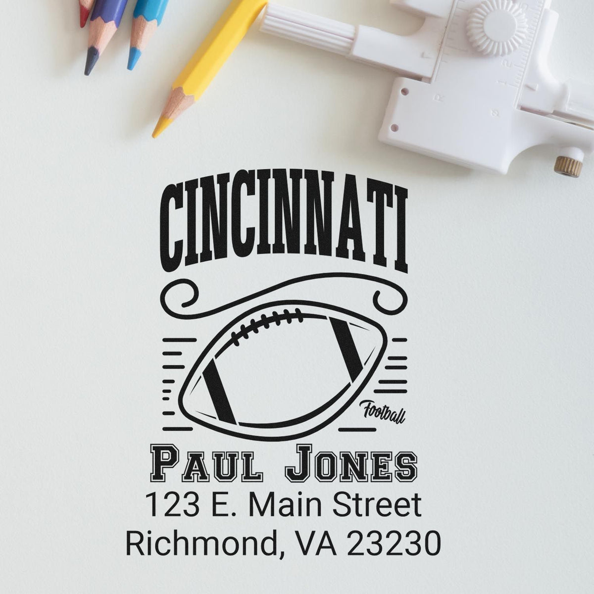 Custom personalized address rubber stamp for Cincinnati football fan Paul Jones, with football logo and Richmond, VA return address.