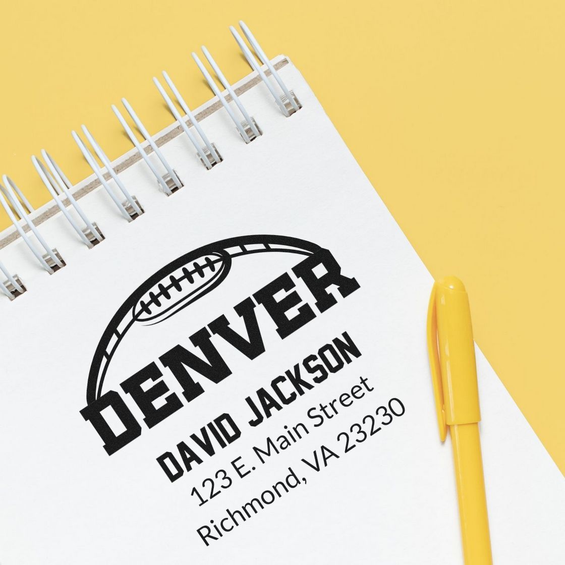 Personalized Denver football rubber stamp with name and address imprint on notebook