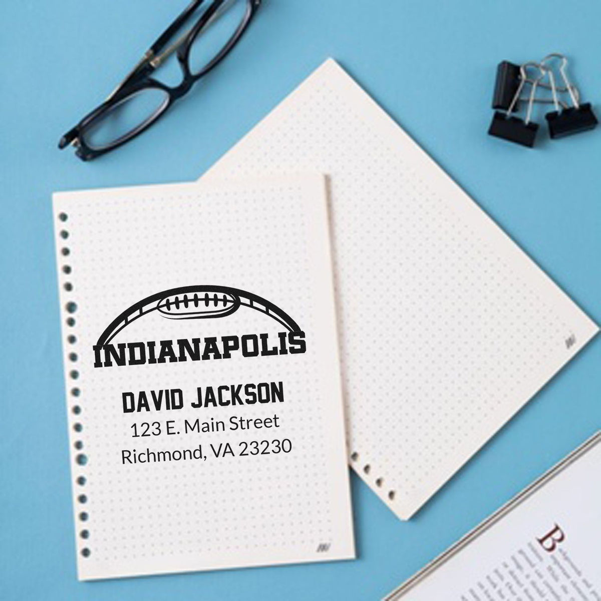 Custom rubber address stamp imprint on notebook with Indianapolis, David Jackson, and mailing address.