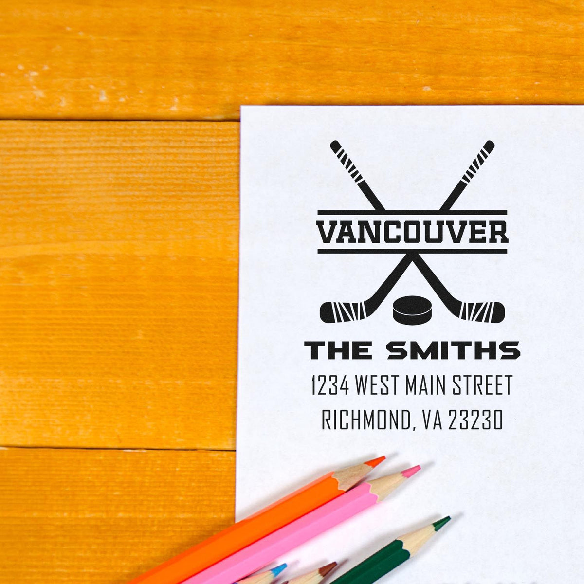 Custom hockey rubber stamp design with Vancouver, The Smiths, and address, stamped on paper with colored pencils.
