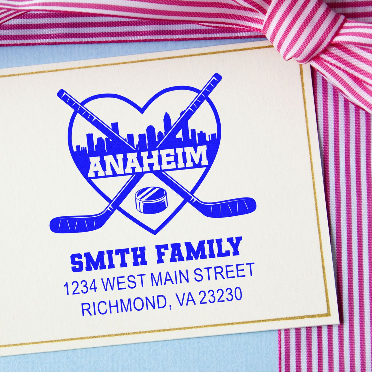 Personalized hockey family rubber stamp with Anaheim skyline, crossed sticks, and return address for custom stationery.