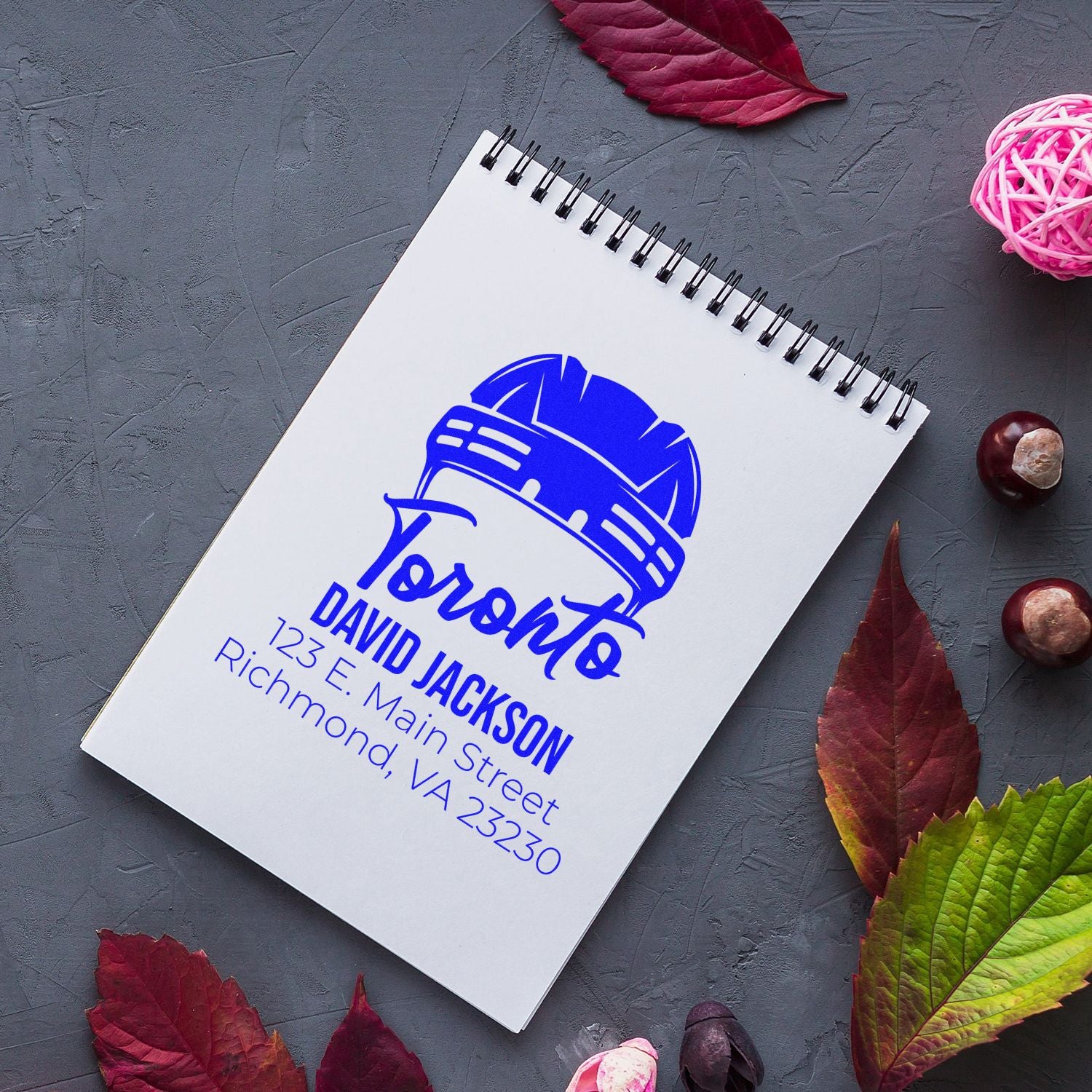 Custom rubber stamp design with Toronto hard hat logo, name, and address for business branding and mailing use.