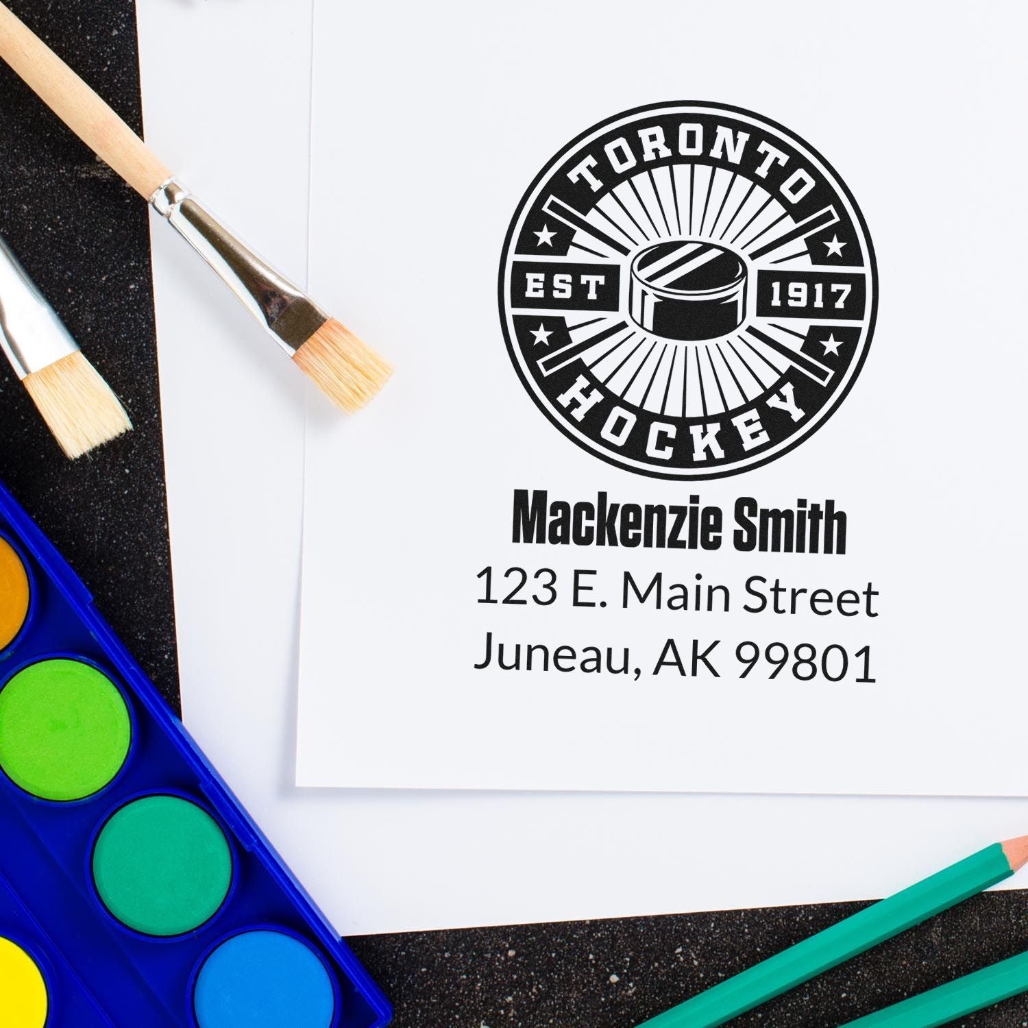 Custom rubber stamp impression with Toronto Hockey logo, name, and address for personalized business branding.
