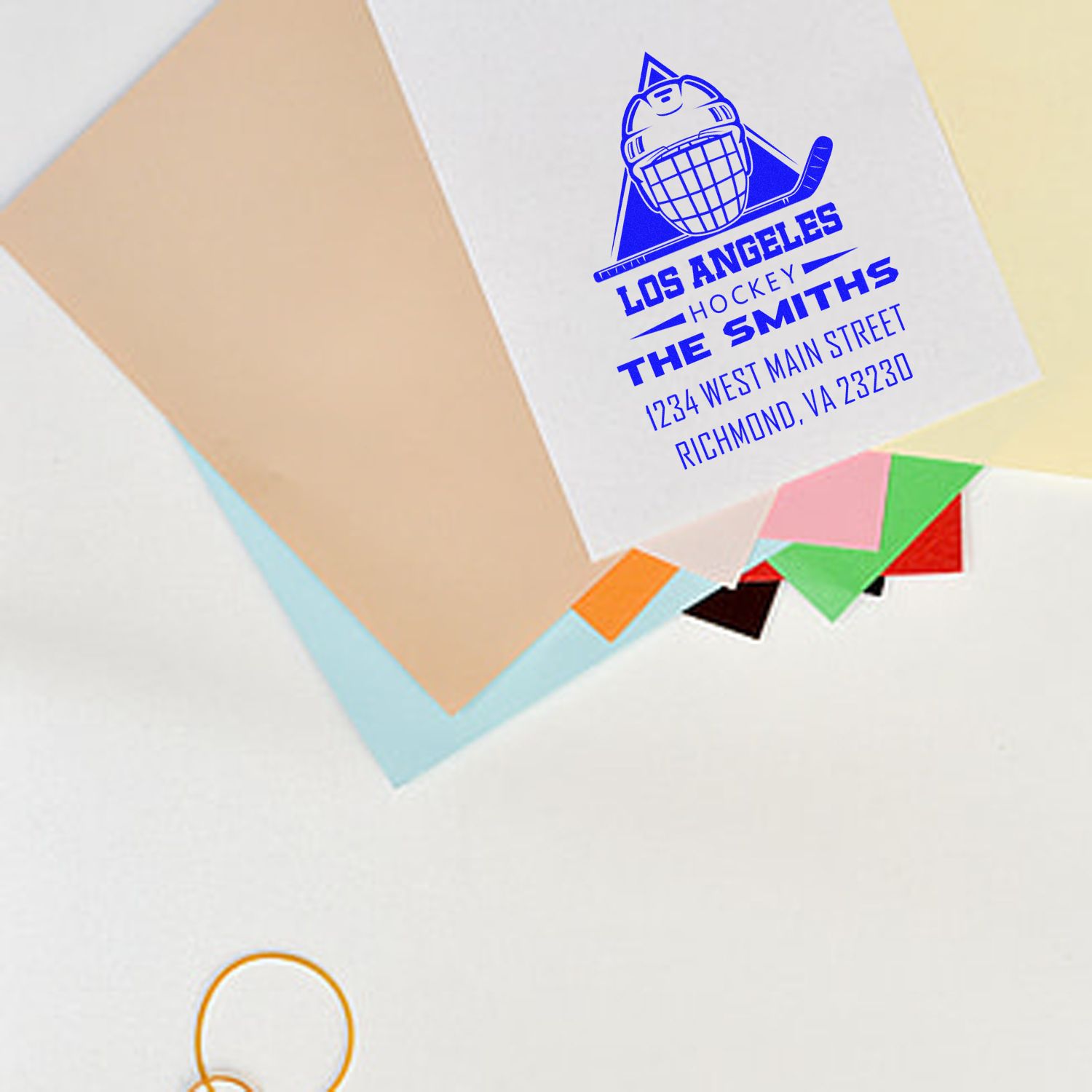 Custom hockey rubber stamp with logo, business name, and address for branded envelopes and packaging.
