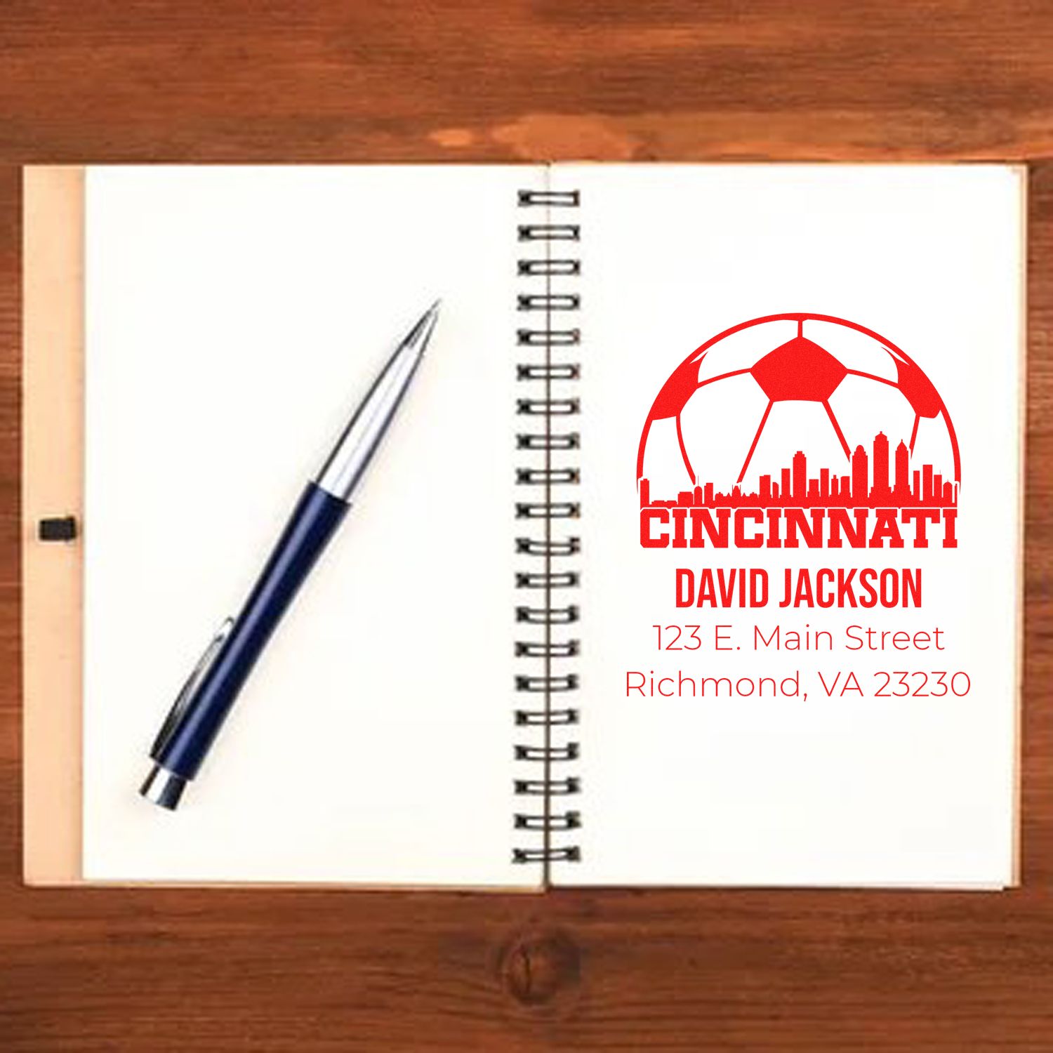 Custom rubber stamp design for Cincinnati David Jackson address, featuring soccer ball and skyline for branded business stationery.