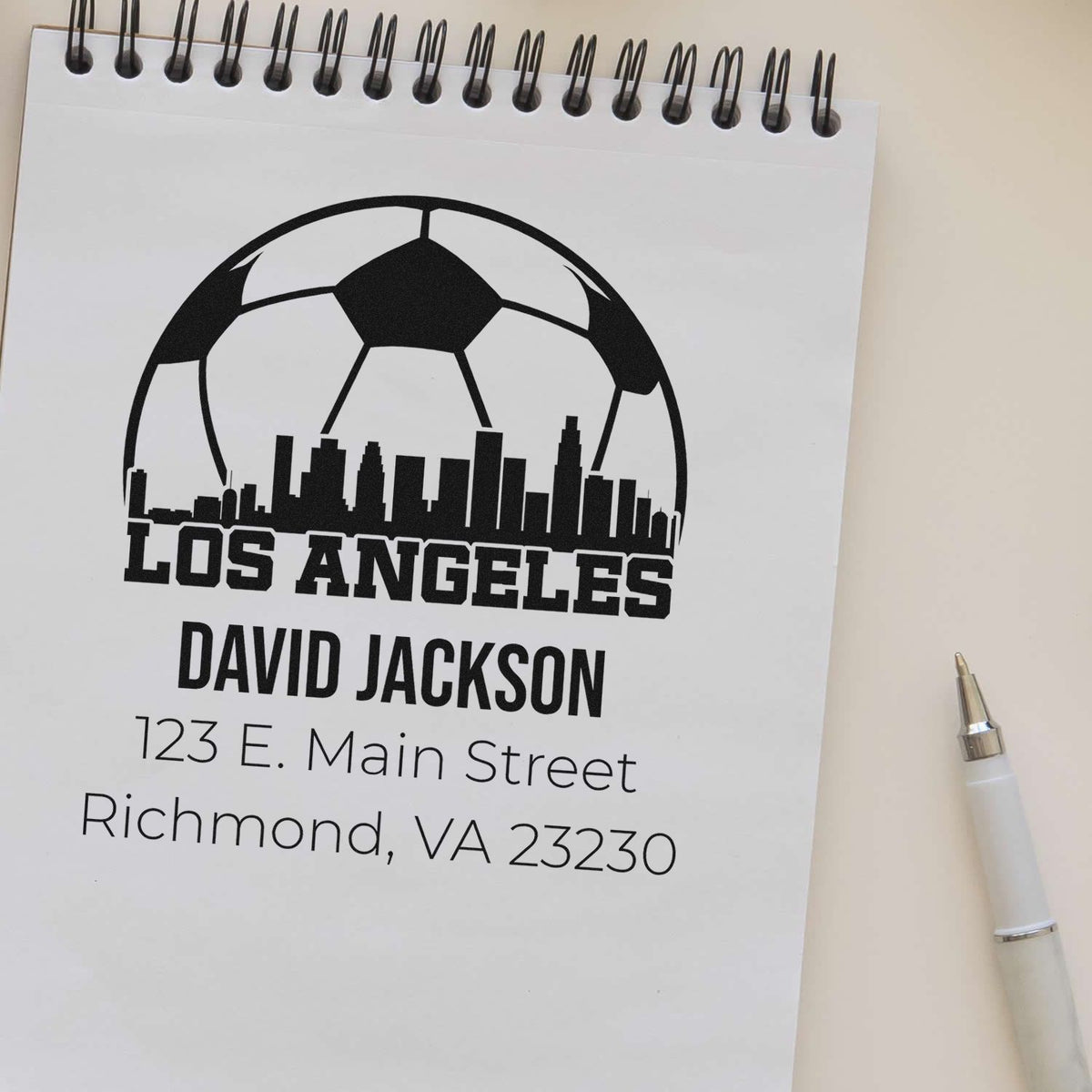 Custom rubber stamp design with soccer ball, Los Angeles skyline, name, and address for personalized branding.