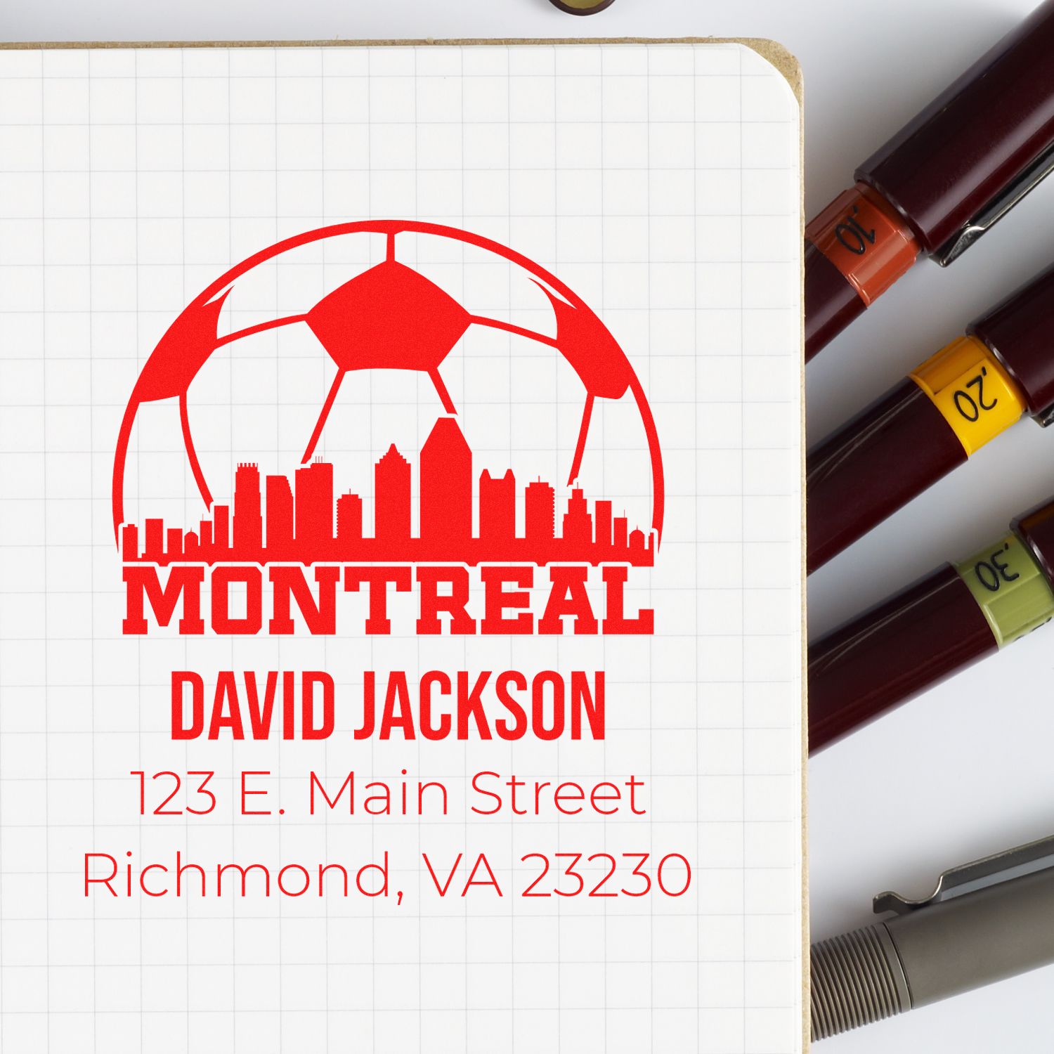Custom Montreal rubber stamp with soccer skyline logo, name, and address for business or mail branding.