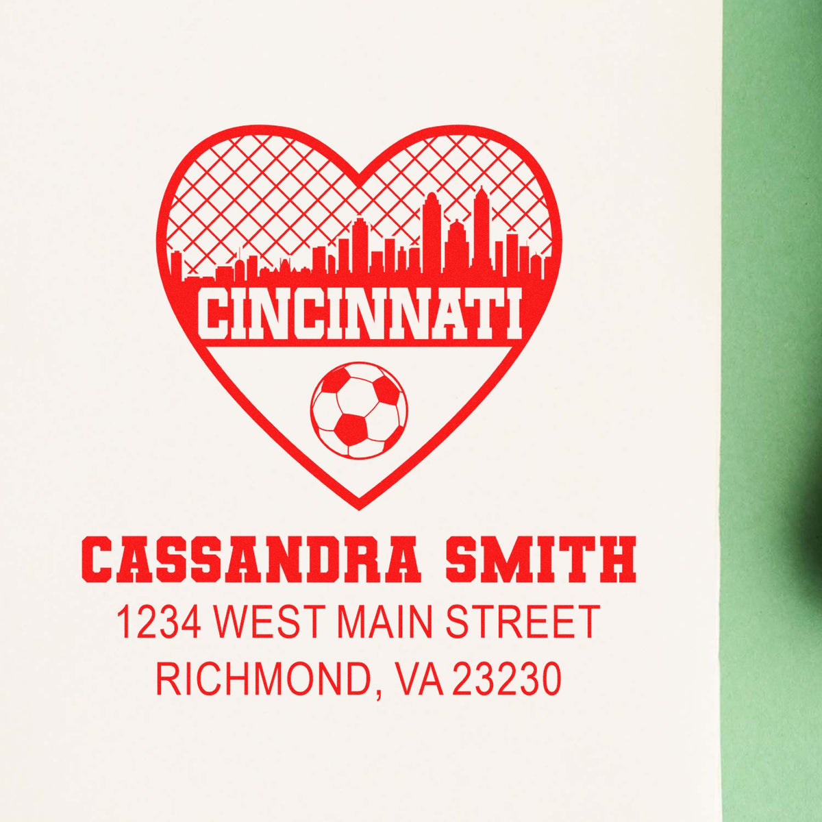 Custom rubber stamp proof with Cincinnati heart skyline, soccer ball, and personalized Cassandra Smith address text.