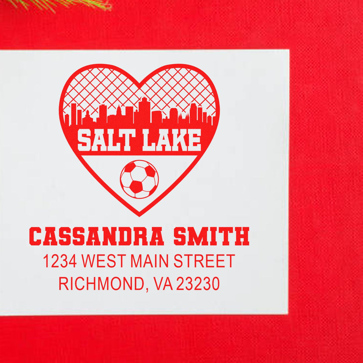 Custom return address rubber stamp with Salt Lake heart skyline, soccer ball, and Cassandra Smith address.