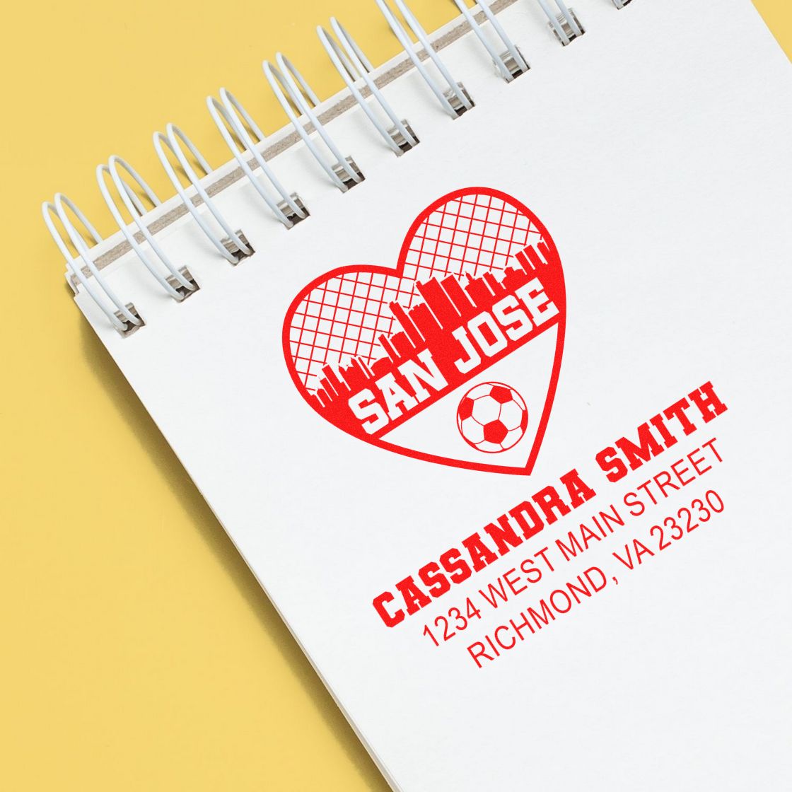 Custom rubber stamp with San Jose heart logo and Cassandra Smith address for personalized business branding.