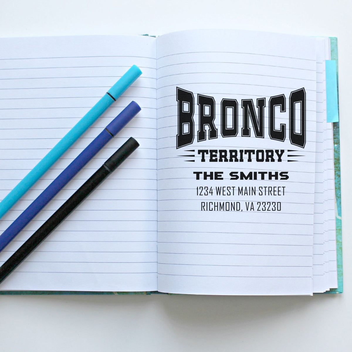 Custom rubber address stamp impression in notebook: Bronco Territory design with The Smiths and Richmond, VA address.