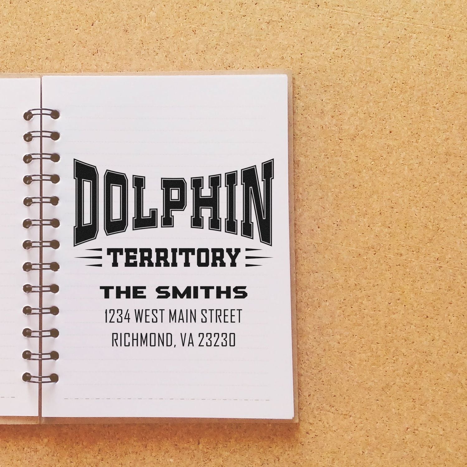 Custom personalized rubber stamp for Dolphin Territory, featuring The Smiths and Richmond, VA address on a notebook.
