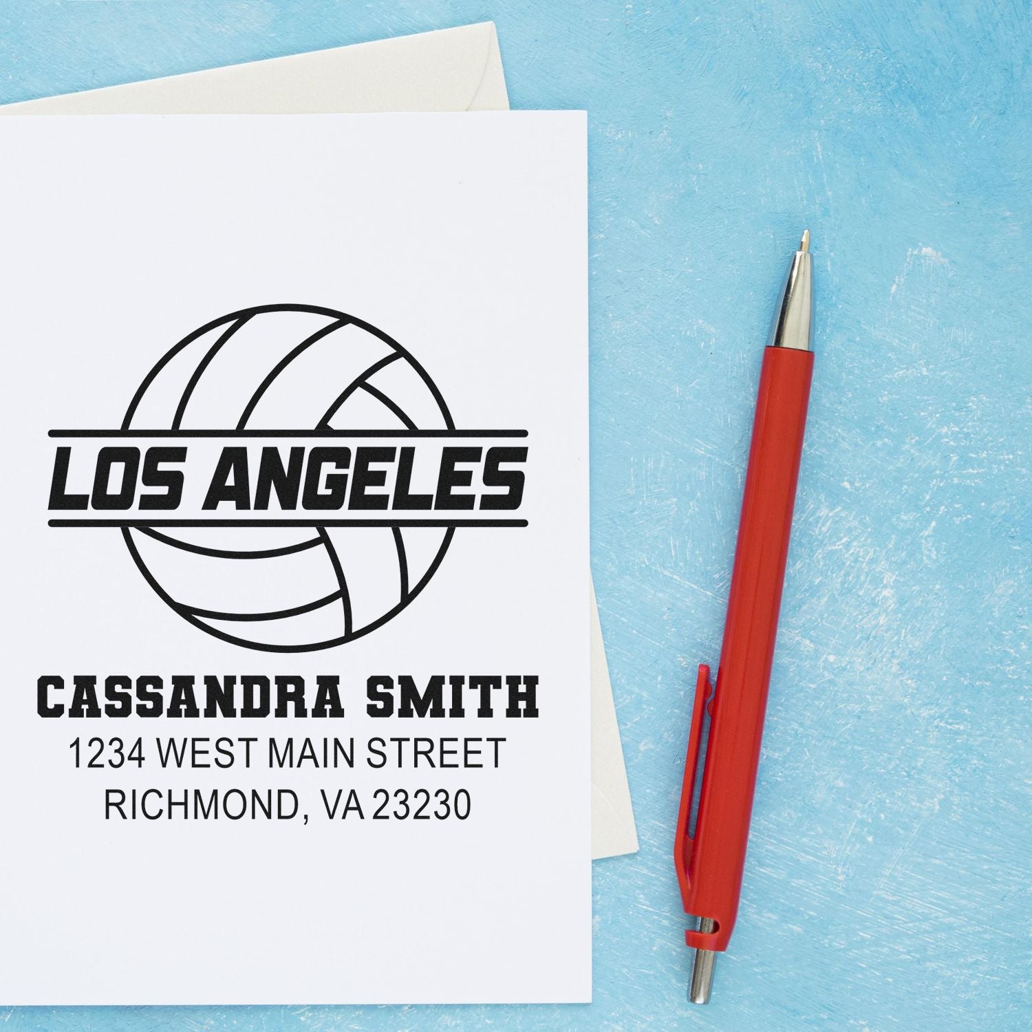 Personalized return address rubber stamp with Los Angeles volleyball logo, name, and address on stationery.