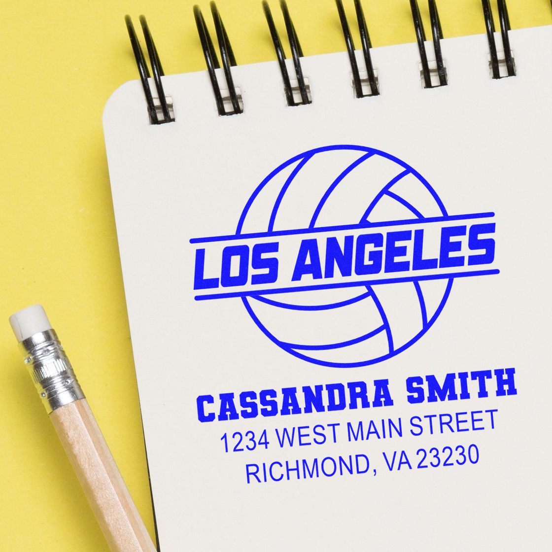 Custom rubber stamp for volleyball logo and address, featuring Los Angeles and Cassandra Smith on a notebook page.