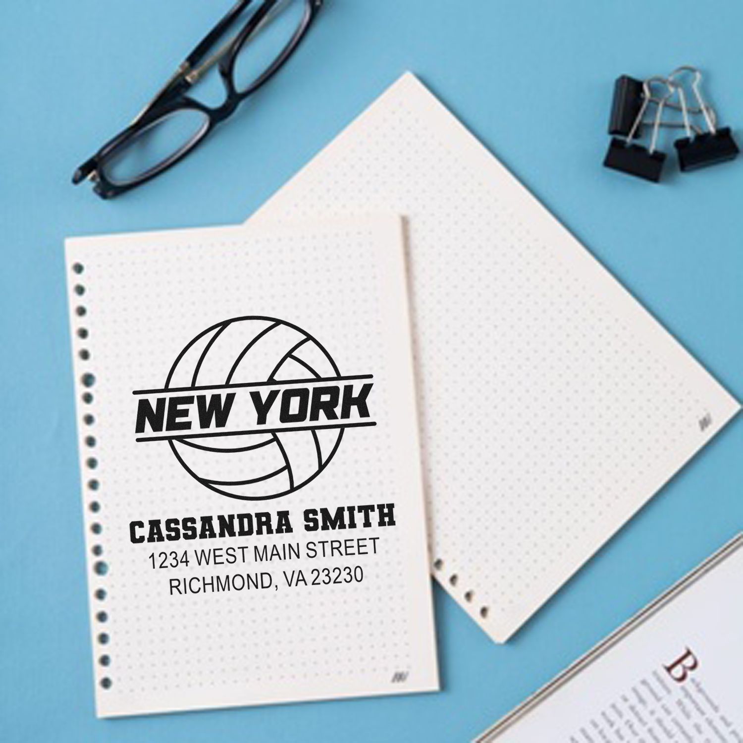 Custom rubber return address stamp with New York design and personalized name and address on notebook paper.