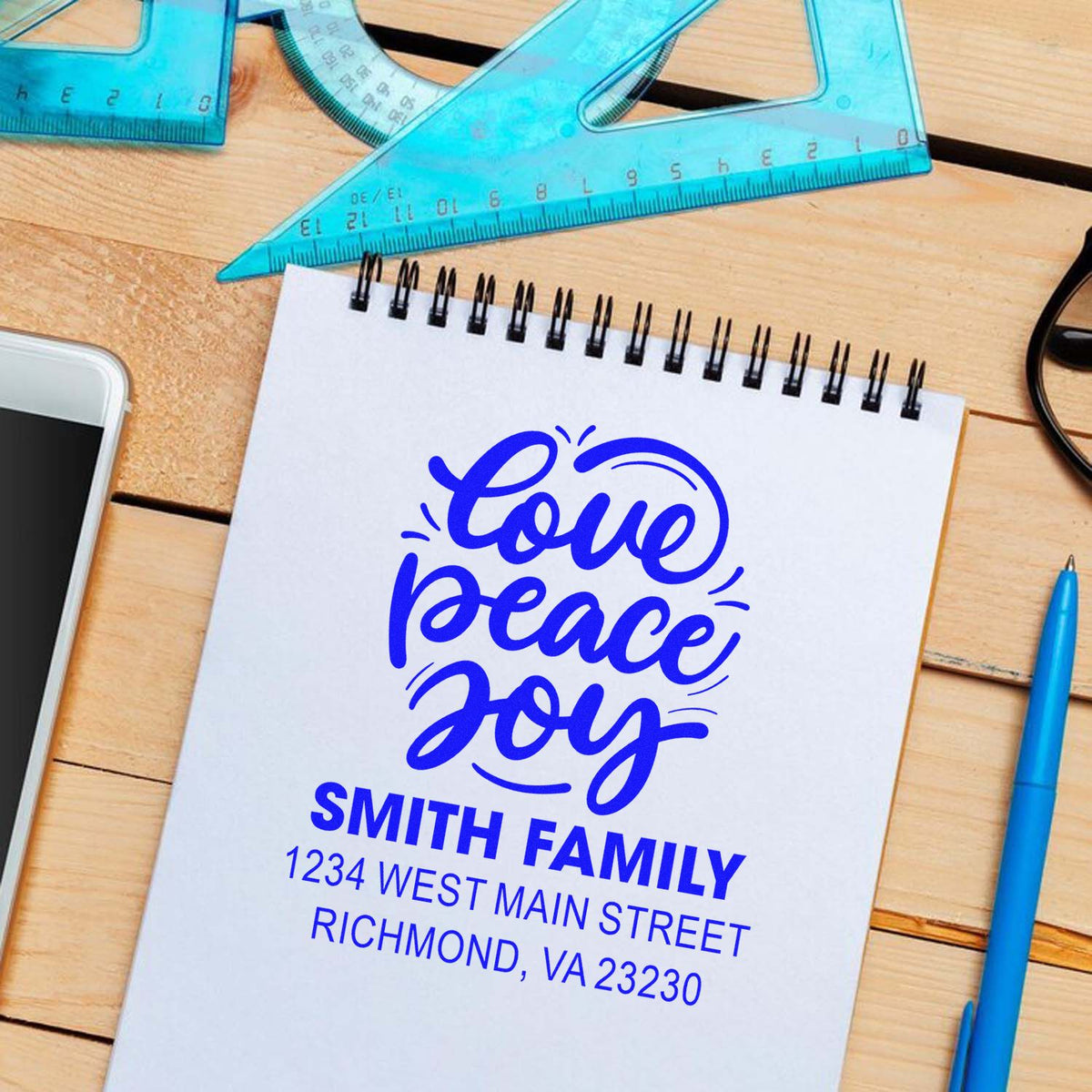 Custom rubber address stamp mockup with Love Peace Joy, Smith Family name, and Richmond, VA return address.