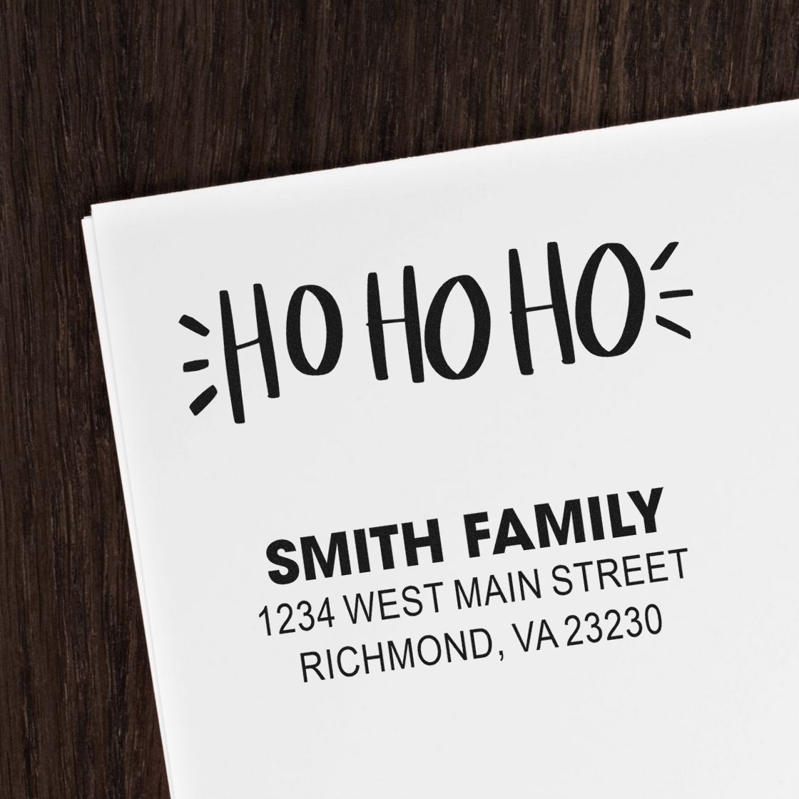 Custom personalized holiday address stamp with HO HO HO design and Smith Family return address for Christmas mailings.