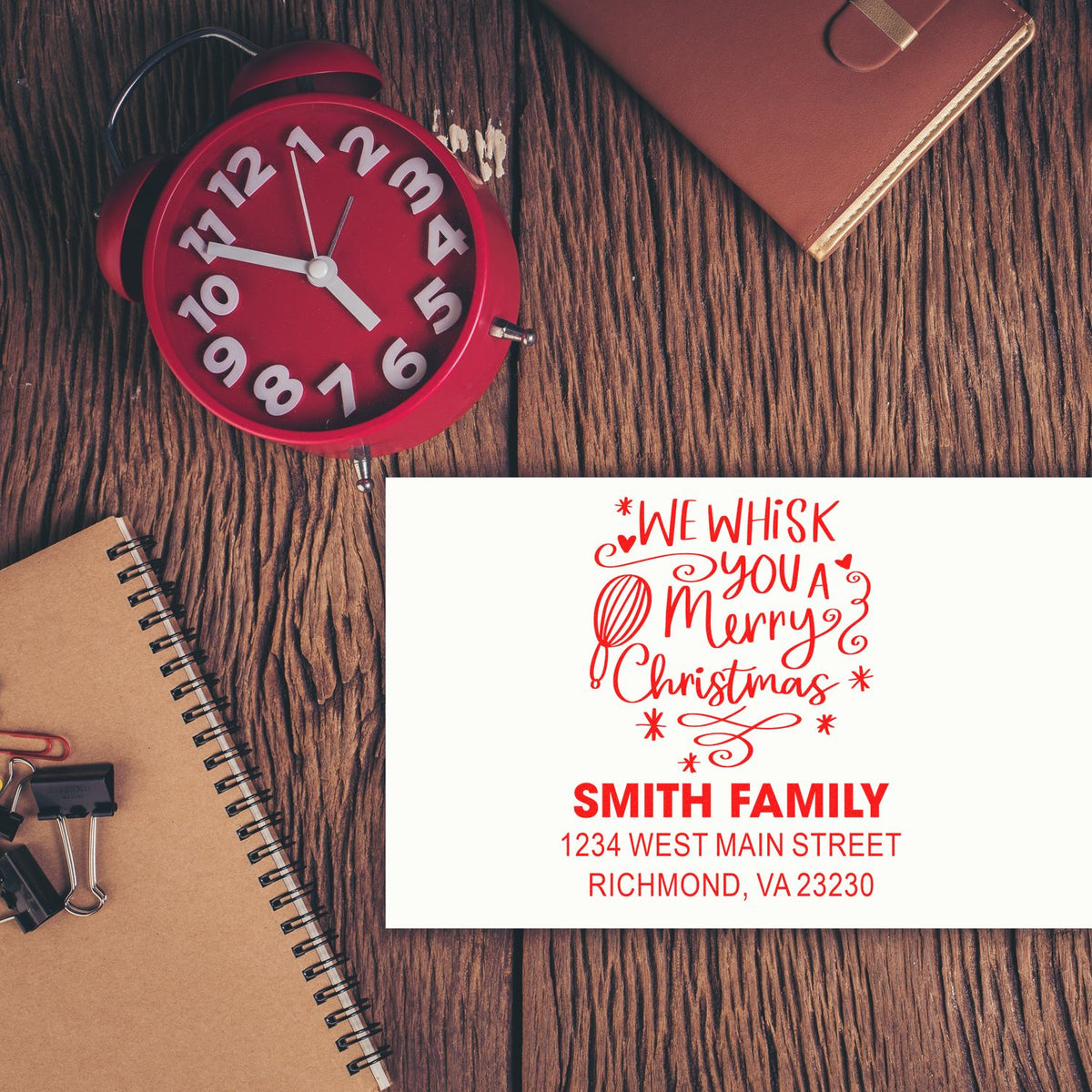 Personalized Christmas rubber stamp sample with We Whisk You a Merry Christmas and Smith Family return address.