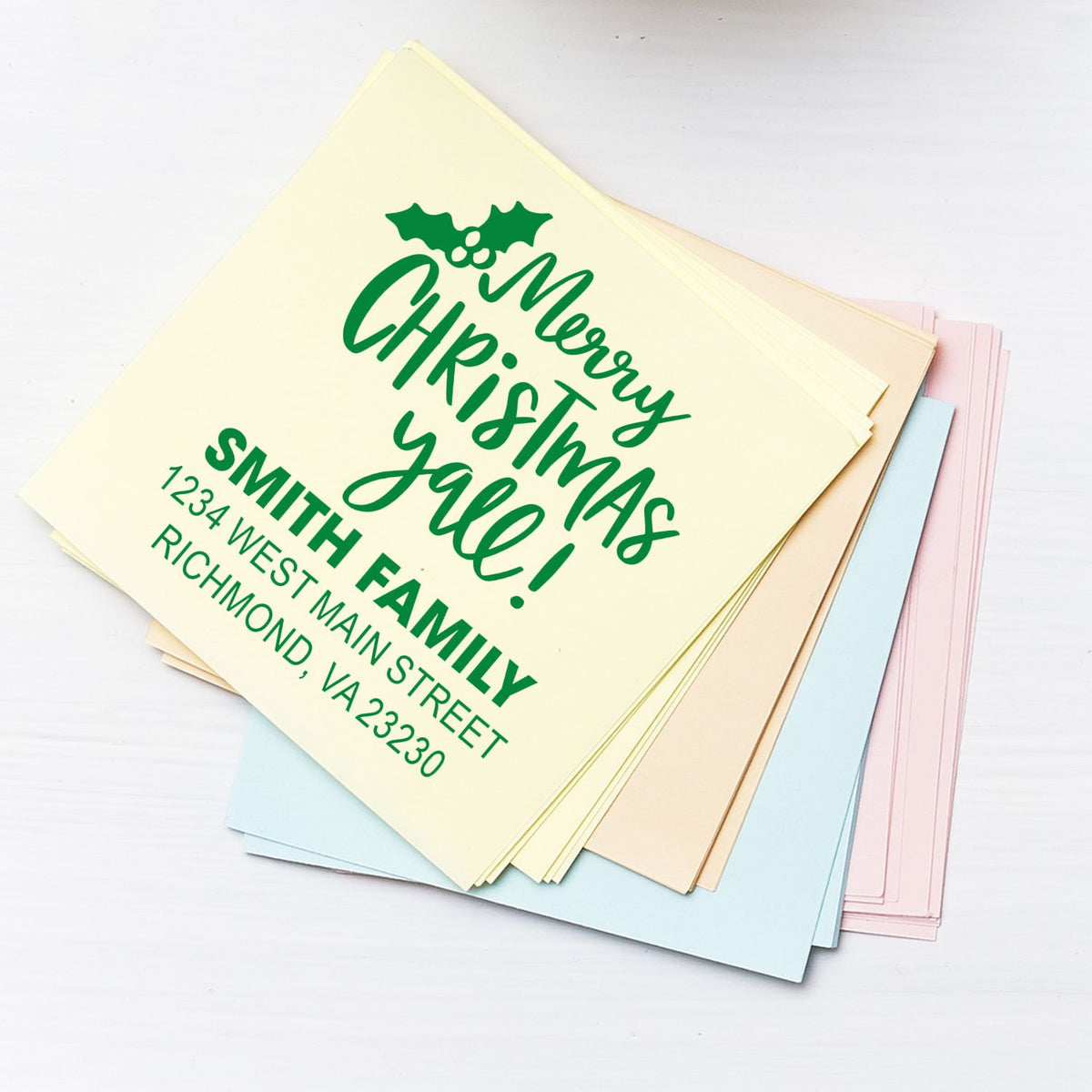 Custom Merry Christmas Y'all Smith Family rubber stamp on pastel stationery for holiday cards and festive return addresses.