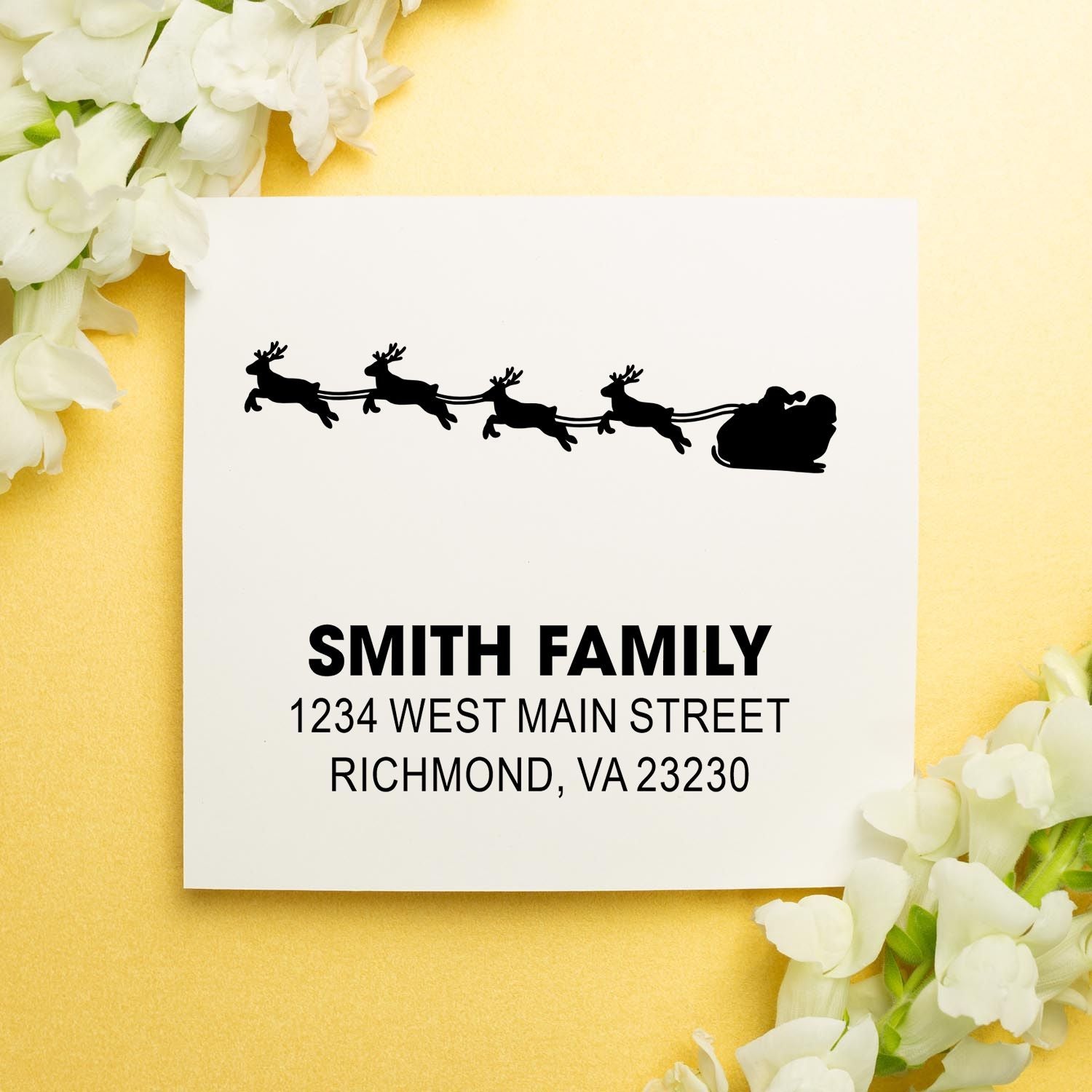 Custom holiday address rubber stamp with Santa sleigh and reindeer, featuring Smith family name and Richmond, VA address for cards.