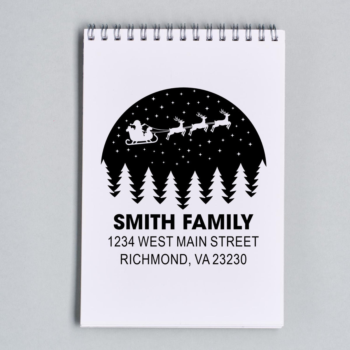 Custom return address rubber stamp with Santa sleigh, reindeer, and pine trees for the Smith family.