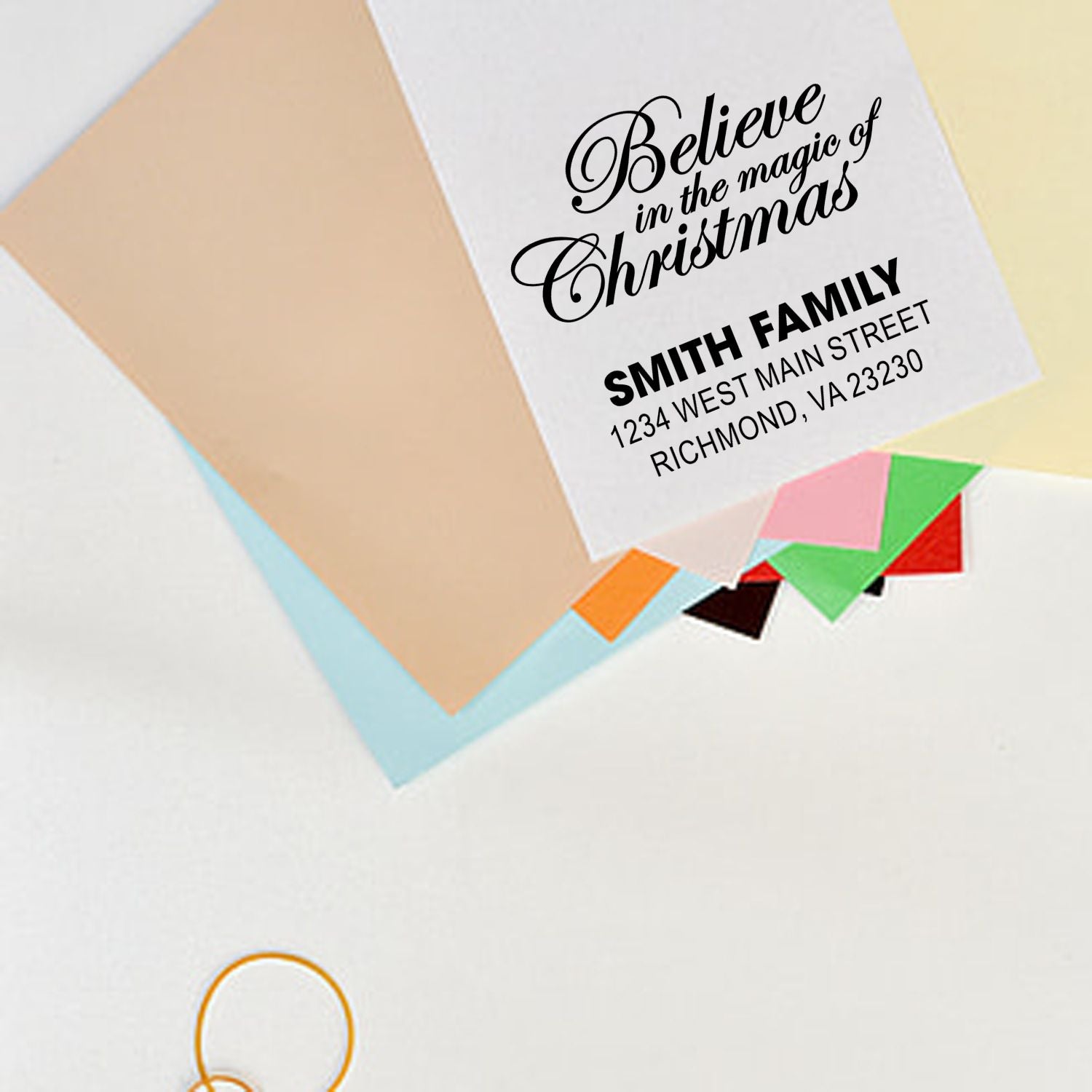 Custom Christmas return address rubber stamp with festive "Believe in the magic of Christmas" design for holiday cards.