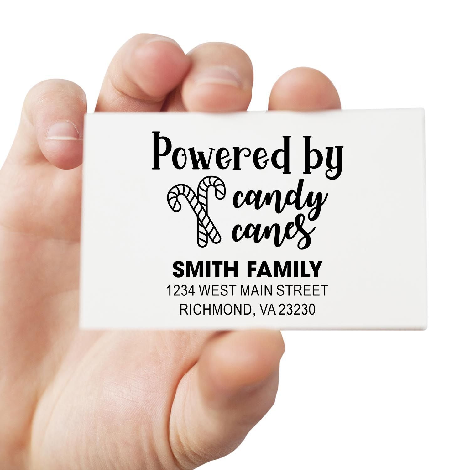 Custom holiday rubber stamp with candy cane design and personalized family address, reading Powered by candy canes.