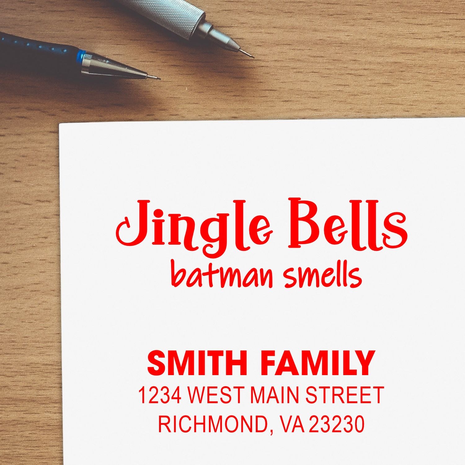 Custom holiday rubber stamp design with Smith Family return address and festive Jingle Bells text on paper.