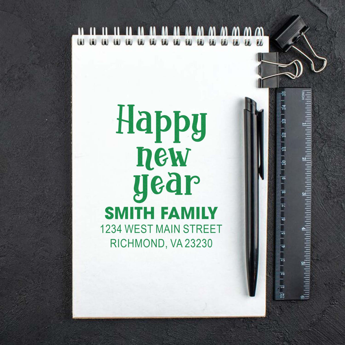 Custom Happy New Year return address rubber stamp imprint with Smith family name and Richmond, VA address on a notepad.