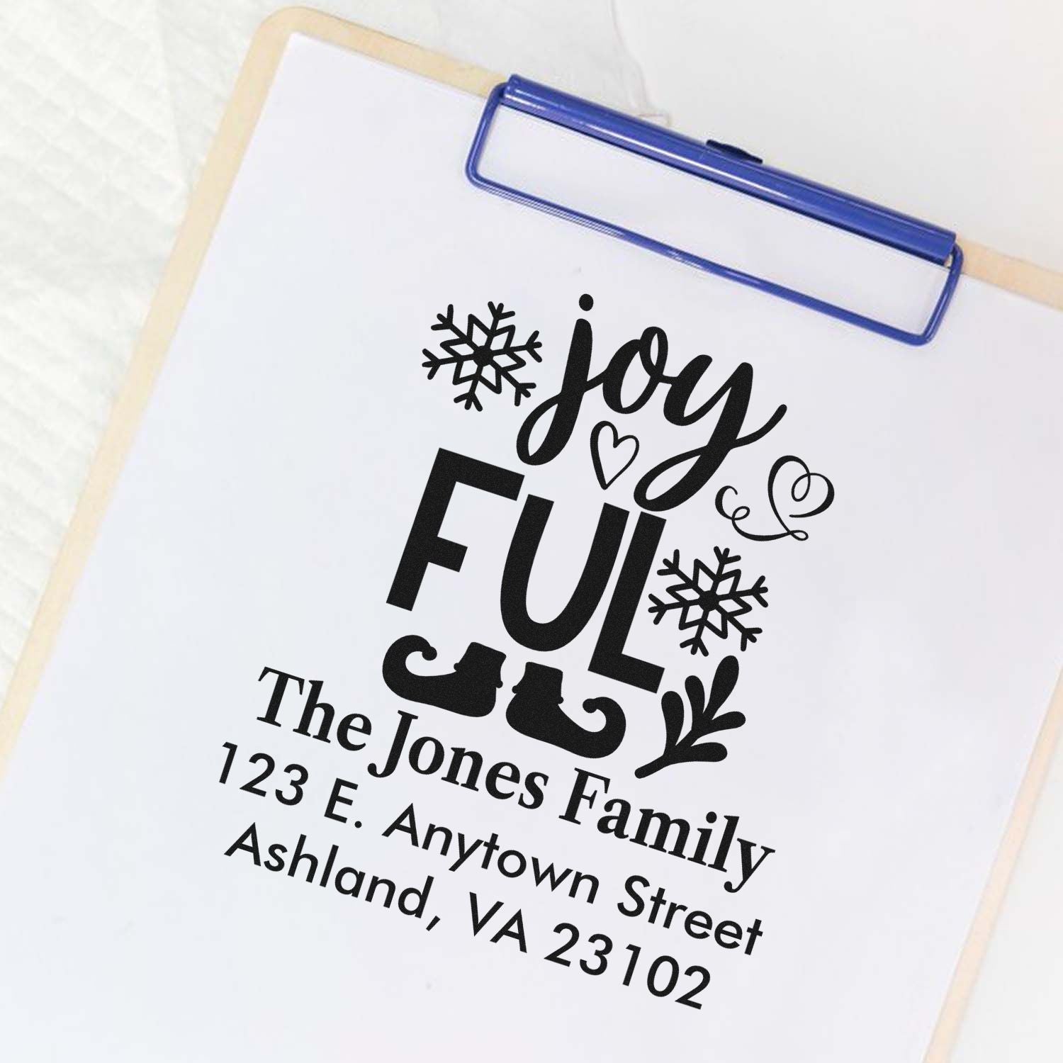 Custom Christmas address rubber stamp with Joyful holiday design for The Jones Family mailing and festive gift packaging.
