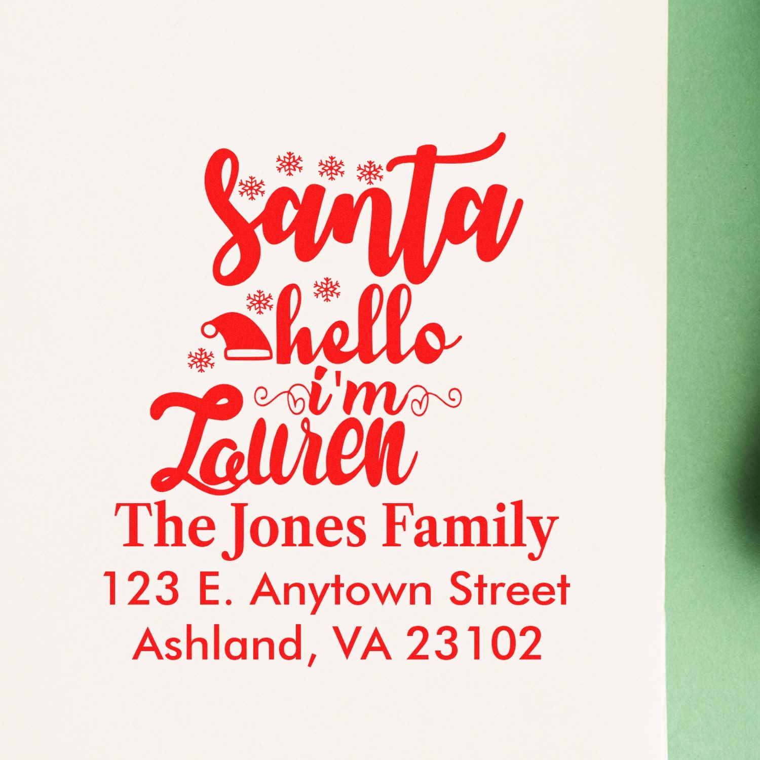 Custom Christmas rubber stamp design with Santa greeting and personalized Jones Family return address for holiday cards.