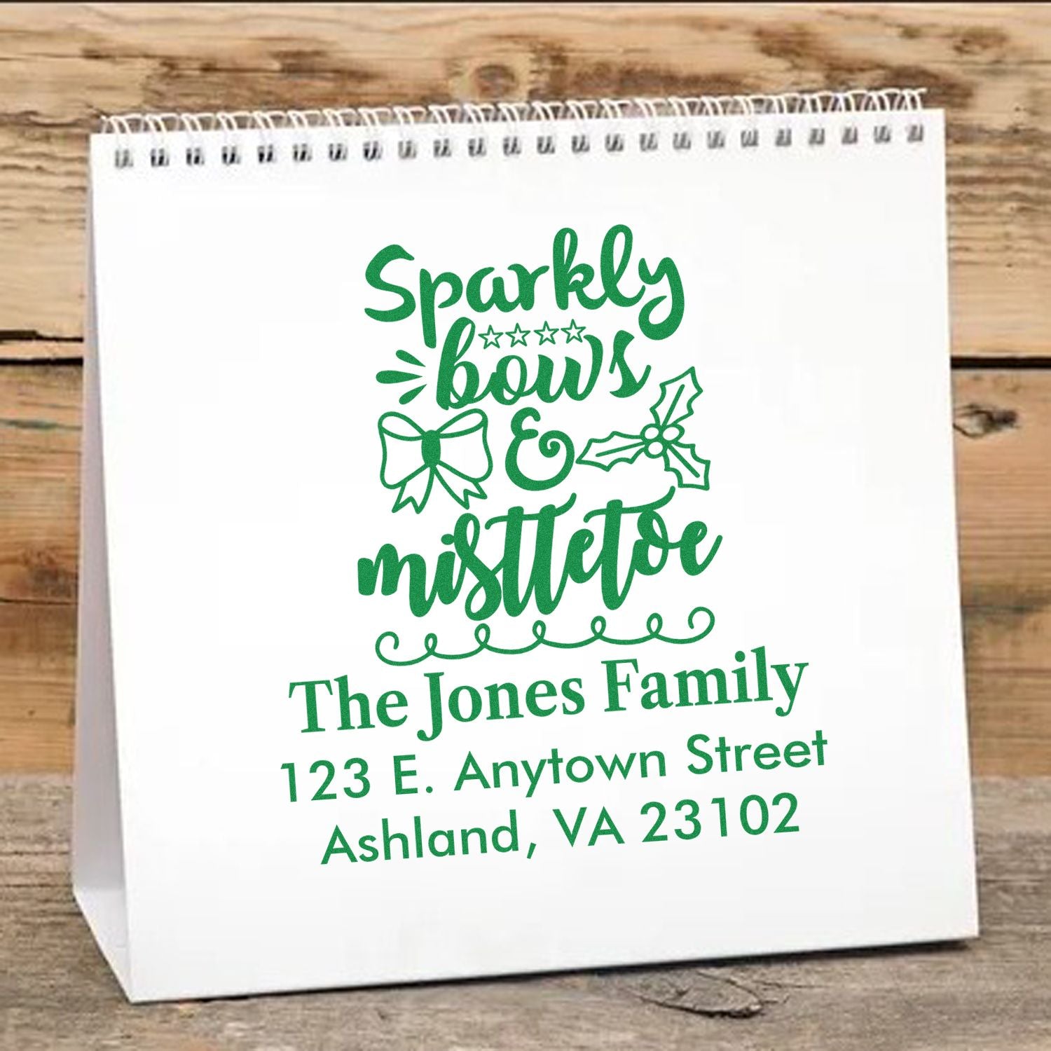 Custom Christmas rubber stamp design with Sparkly Bows & Mistletoe, bow and holly accents, personalized family name and address.
