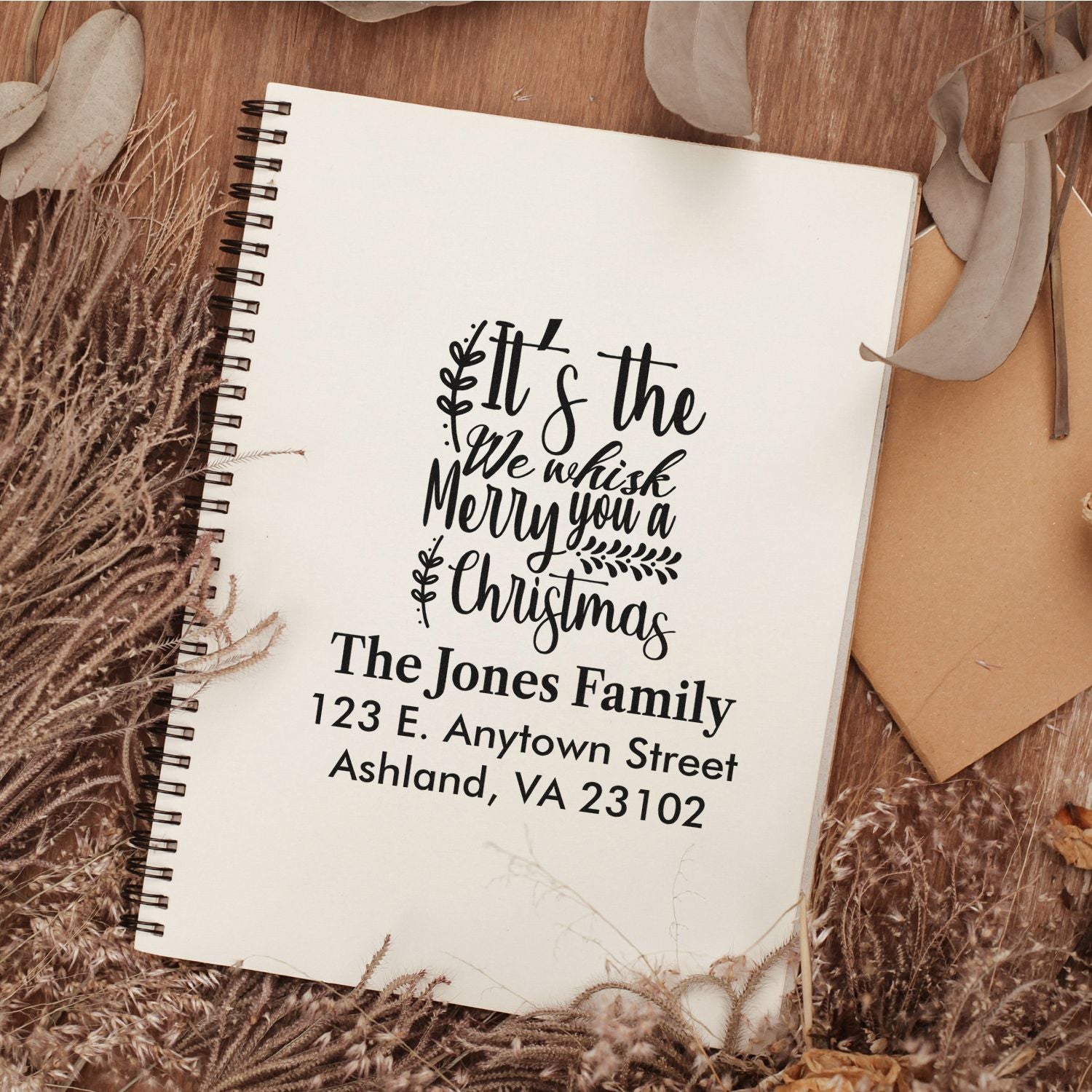 Custom Christmas return address rubber stamp with festive greeting, family name, and mailing address for holiday cards.
