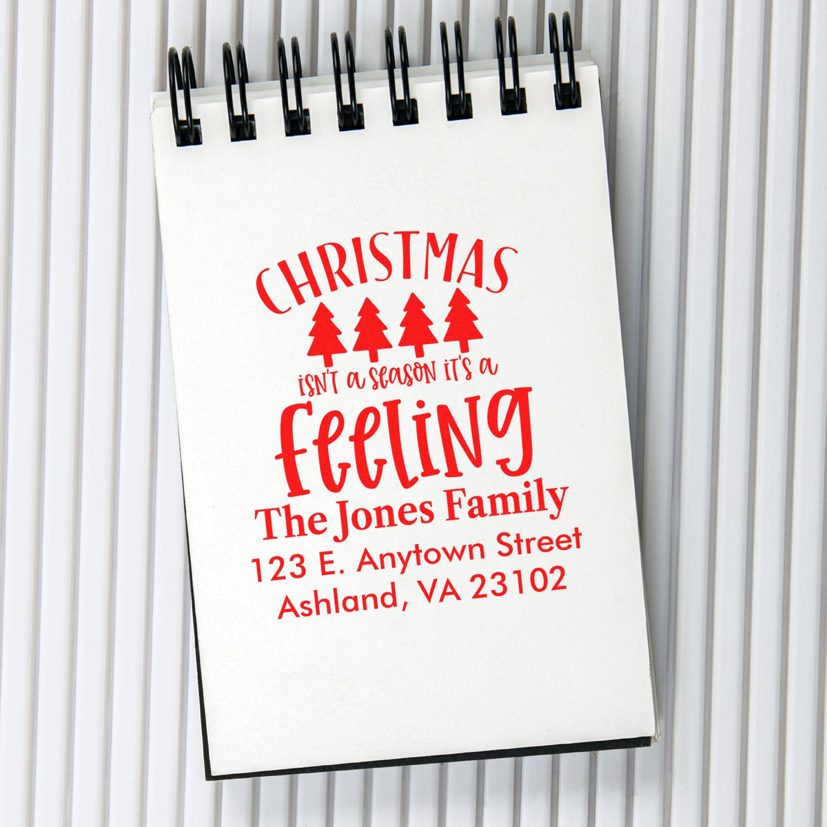 Custom Christmas address rubber stamp design with festive message, family name, and Ashland, VA return address.