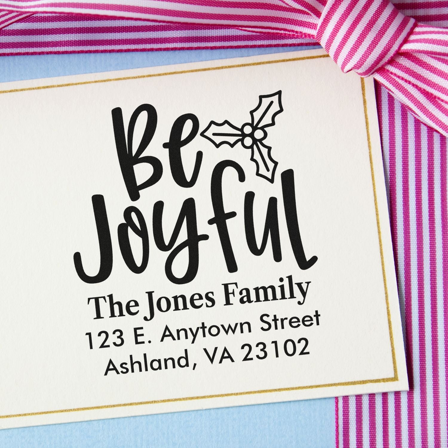 Custom holiday rubber stamp with Be Joyful holly design and family address for personalized Christmas cards.