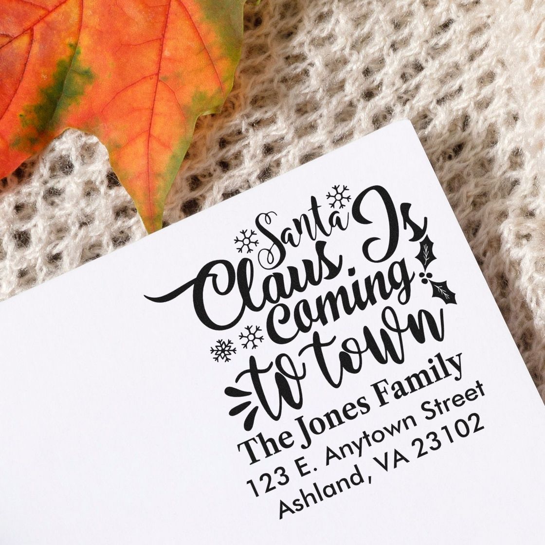 Personalized Christmas address rubber stamp with Santa Claus Is Coming to Town for The Jones Family holiday mailings.