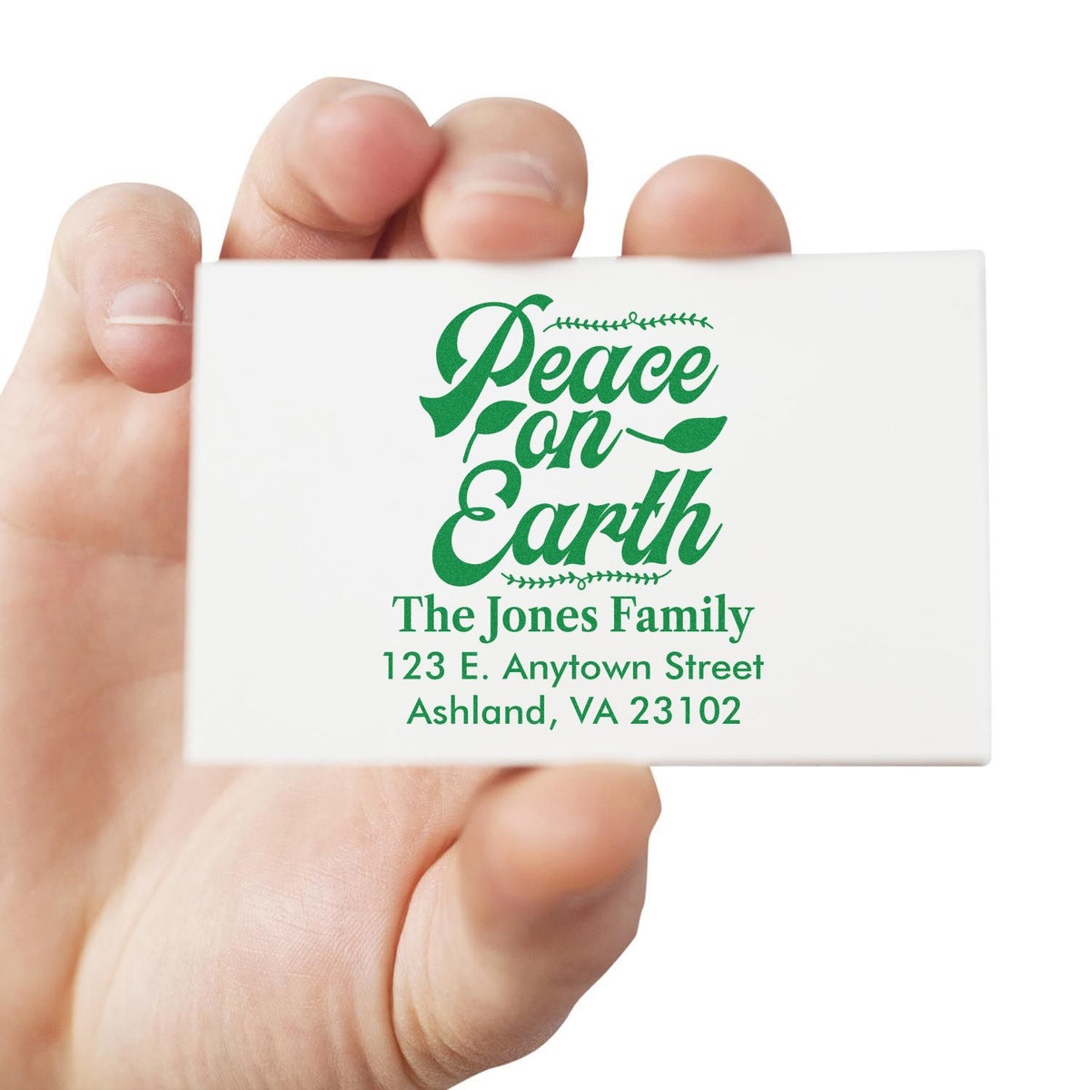 Personalized holiday rubber stamp with Peace on Earth design and family address for cards and envelopes.