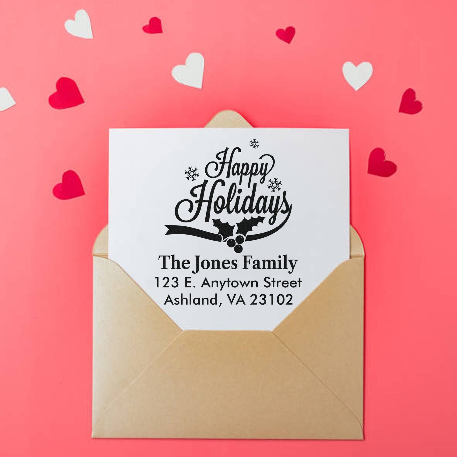 Personalized holiday address rubber stamp on Christmas card in envelope with Happy Holidays design and family return address.