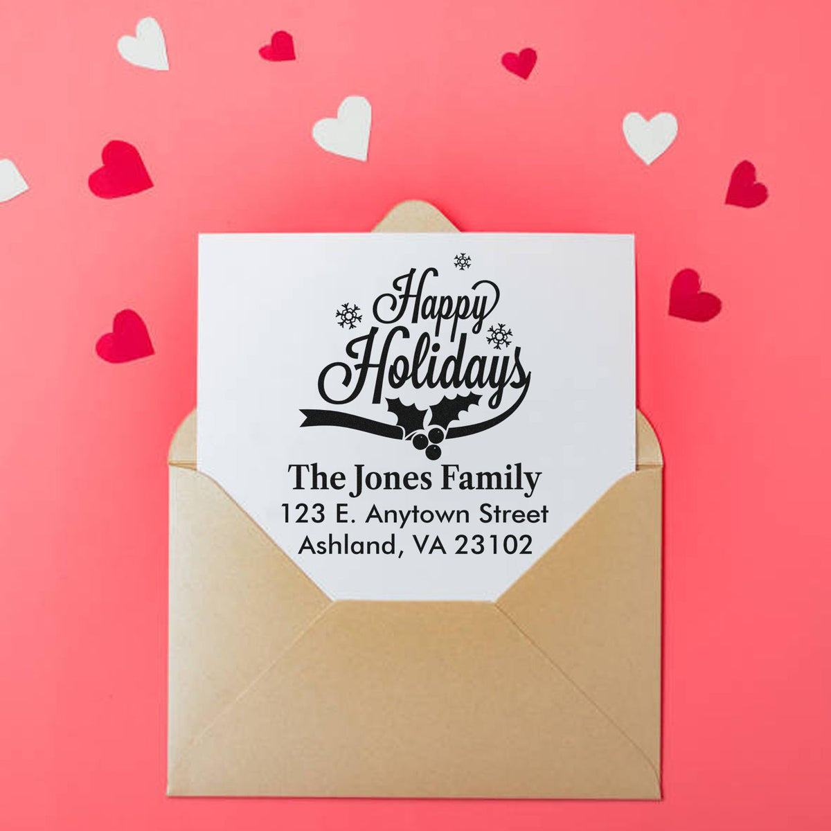 Personalized Happy Holidays rubber stamp with family name and address on an envelope for festive holiday mailing.
