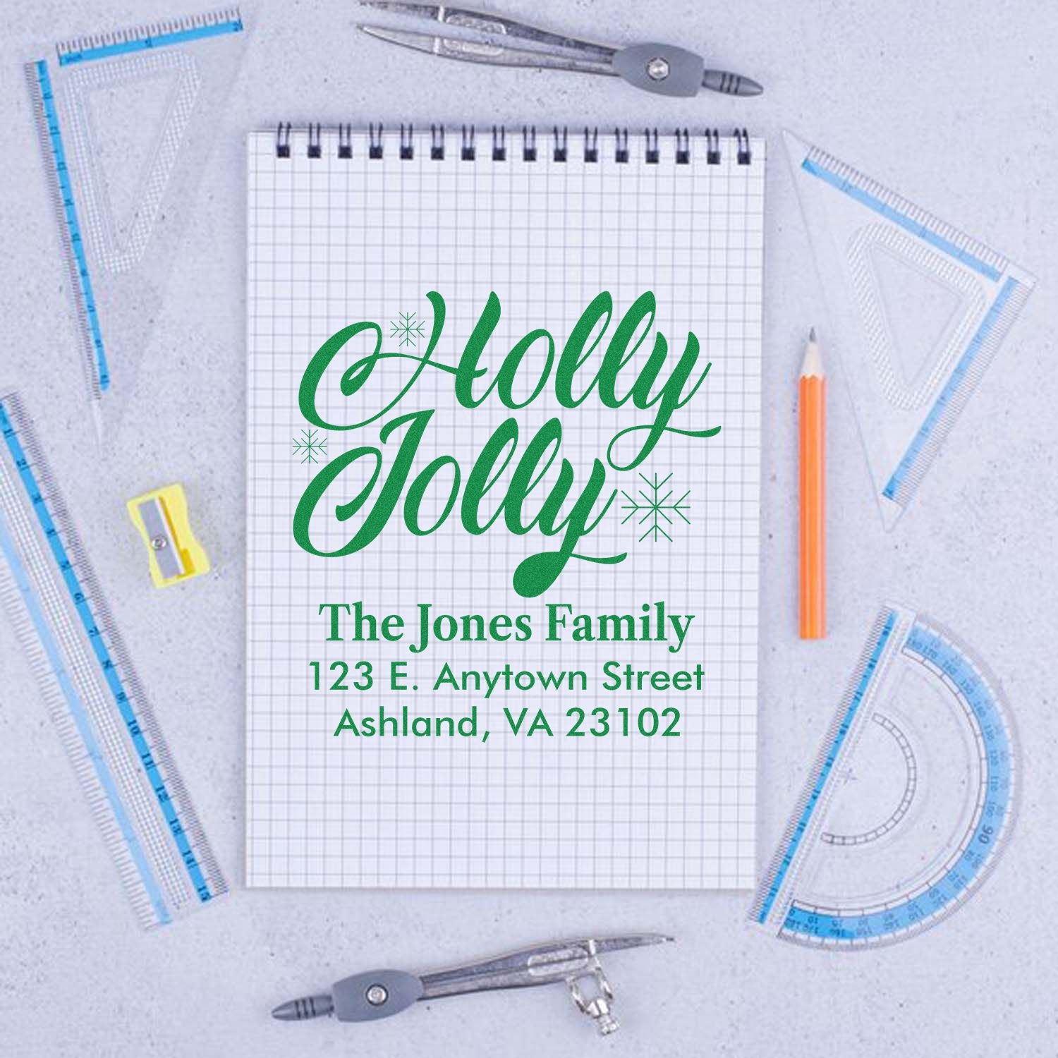 Custom Holly Jolly Christmas address rubber stamp with family name and mailing address in green script.