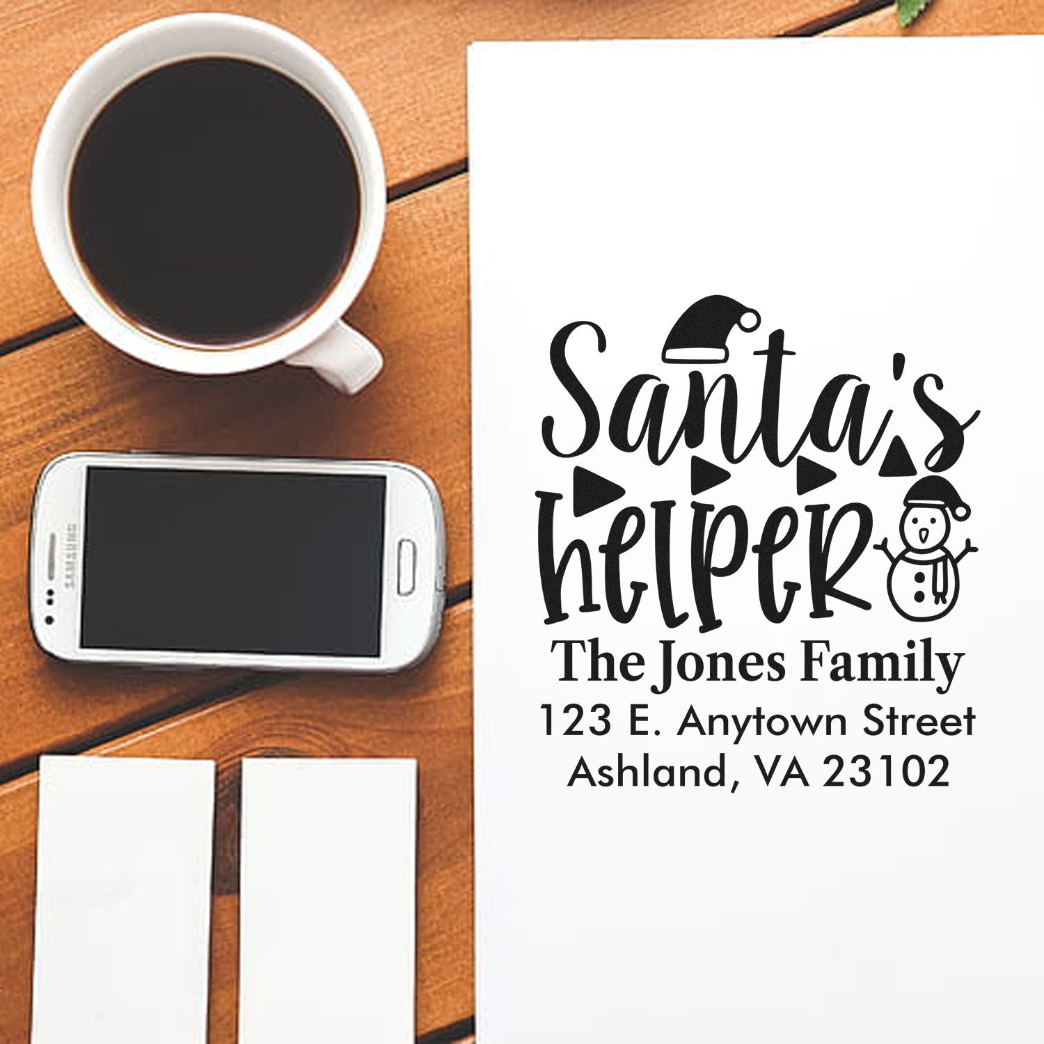 Custom Santas Helper Christmas address rubber stamp for holiday cards, with family name and address.