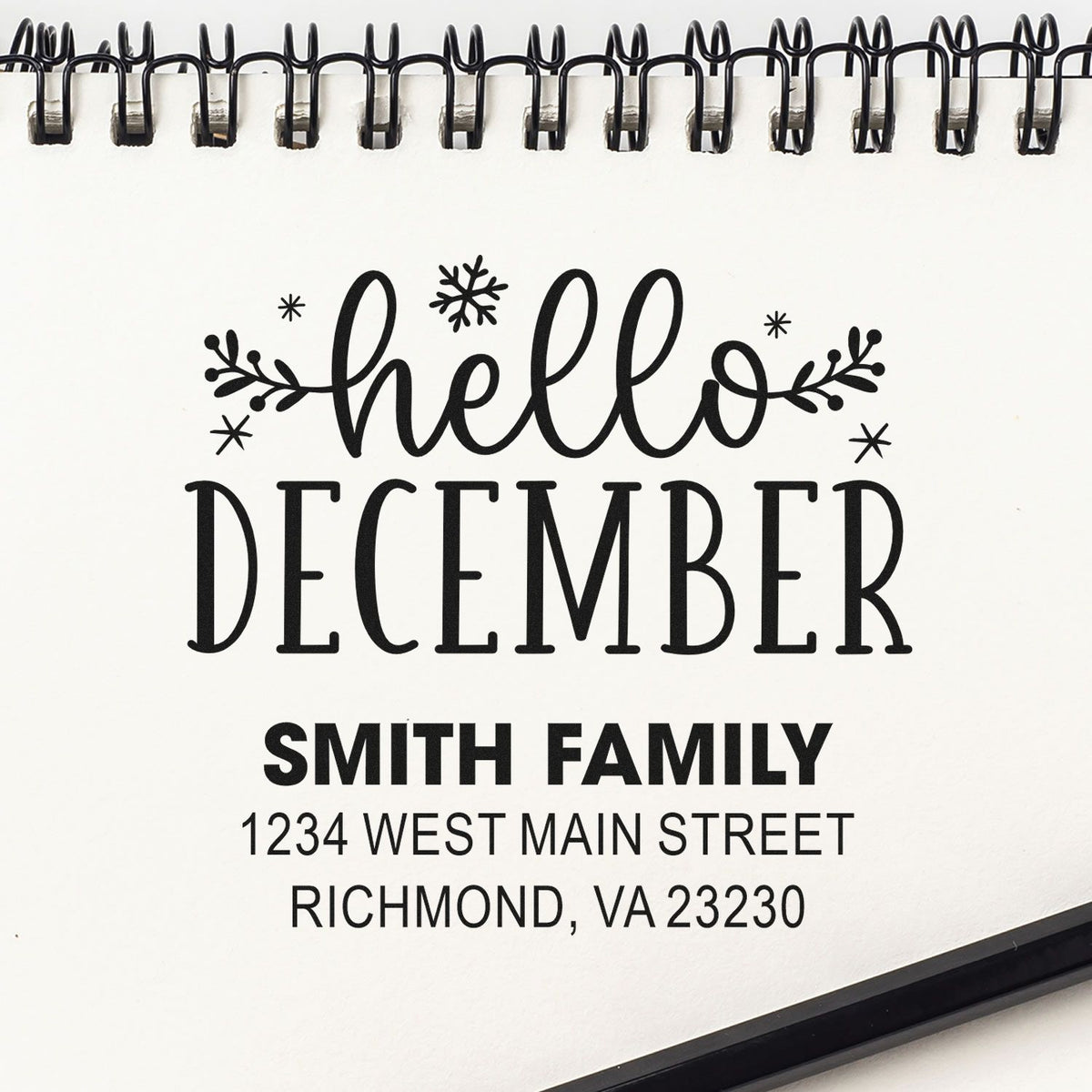 Custom holiday address rubber stamp proof with Hello December and Smith Family, 1234 West Main Street, Richmond, VA.