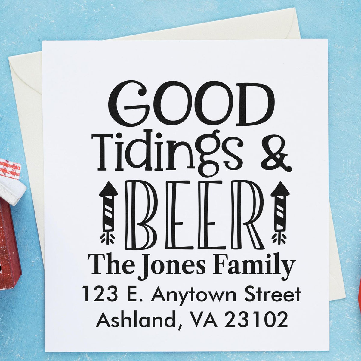 Custom rubber stamp design reading Good Tidings & Beer for The Jones Family, ideal for holiday cards and mailings.