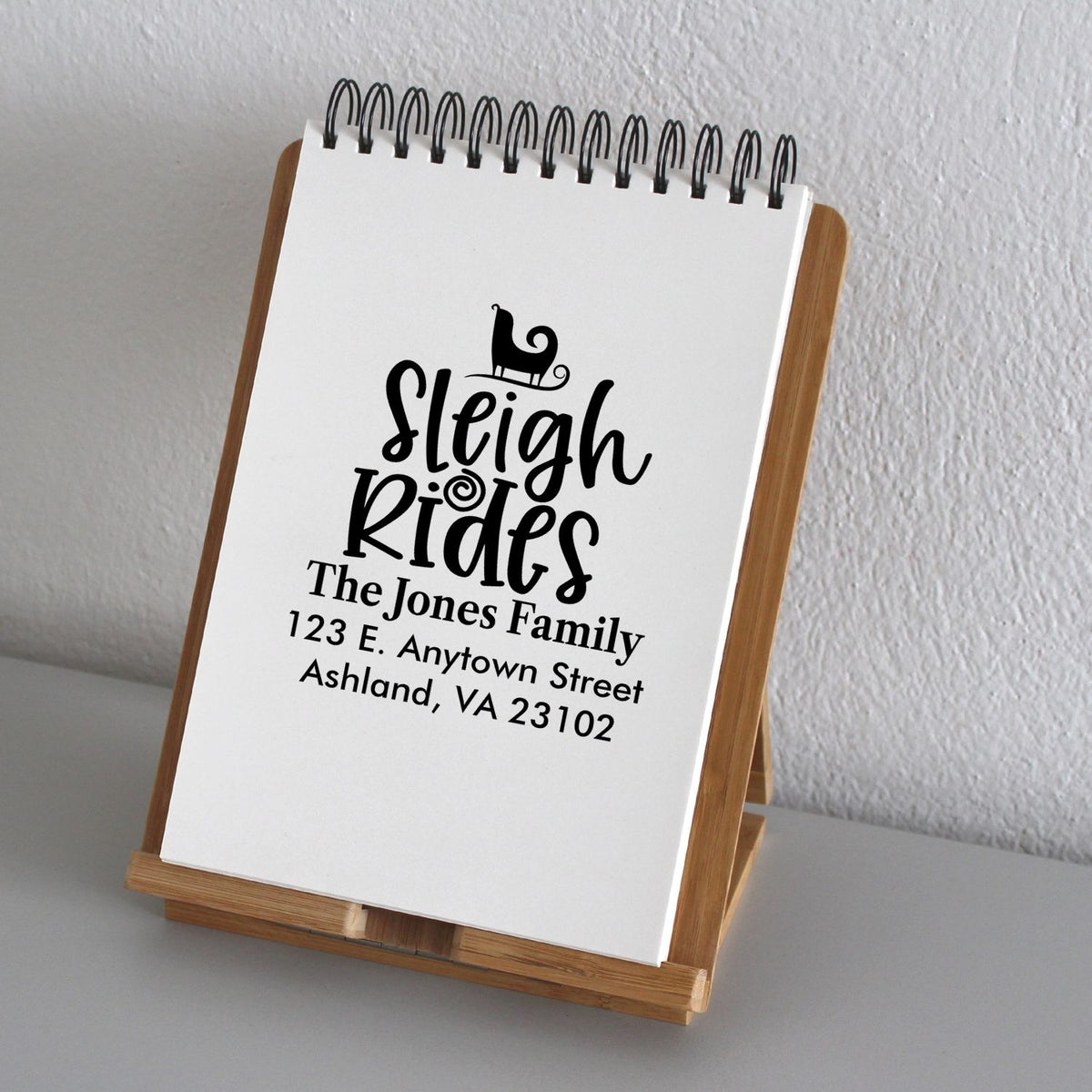 Personalized return address rubber stamp with Sleigh Rides design for The Jones Family holiday mail.