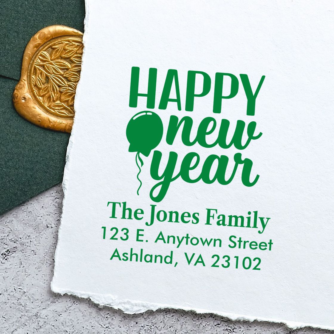 Personalized Happy New Year rubber stamp with custom family name, address, and balloon design in green ink.