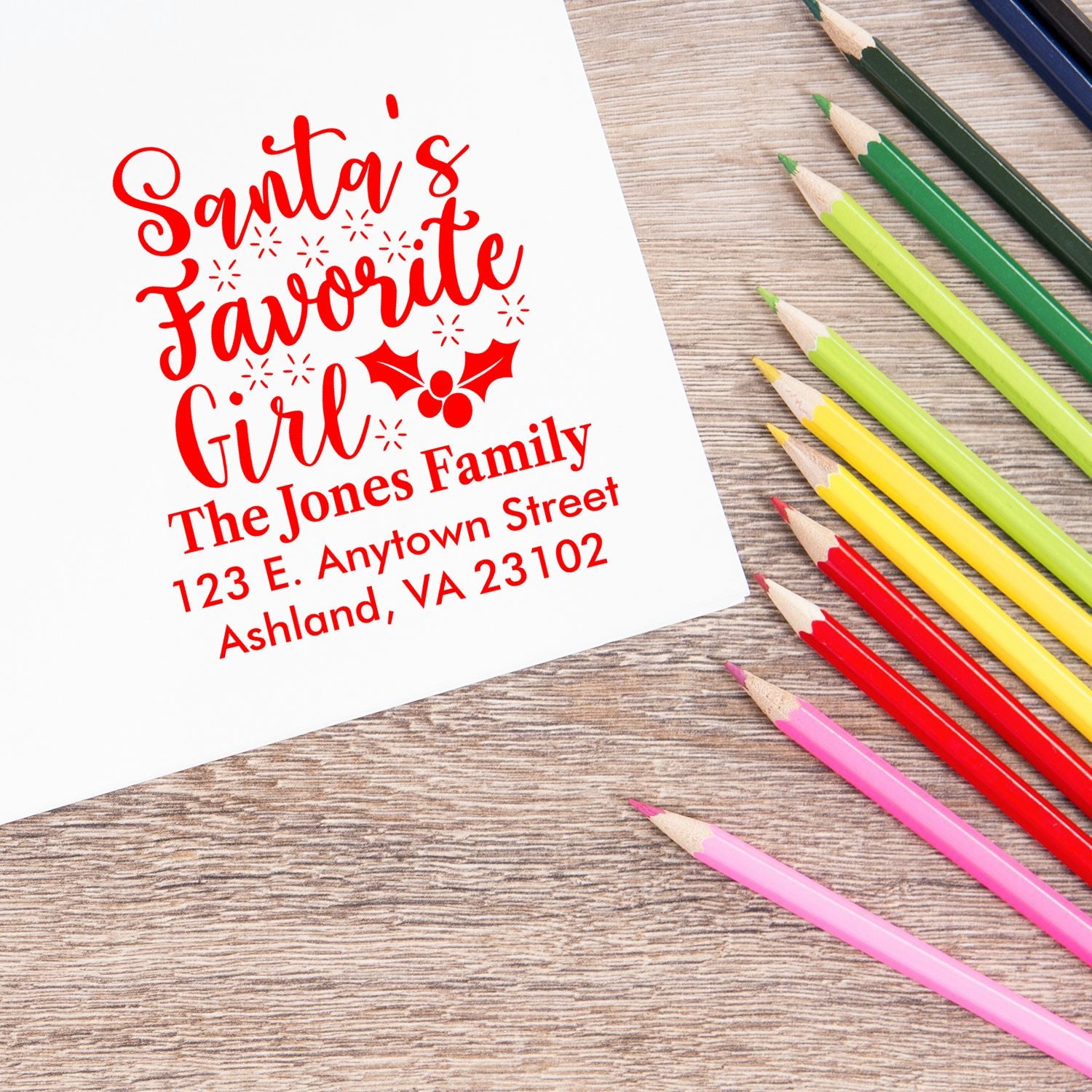 Personalized holiday rubber stamp design with Santas Favorite Girl, family name, and address for Christmas cards and gifts.