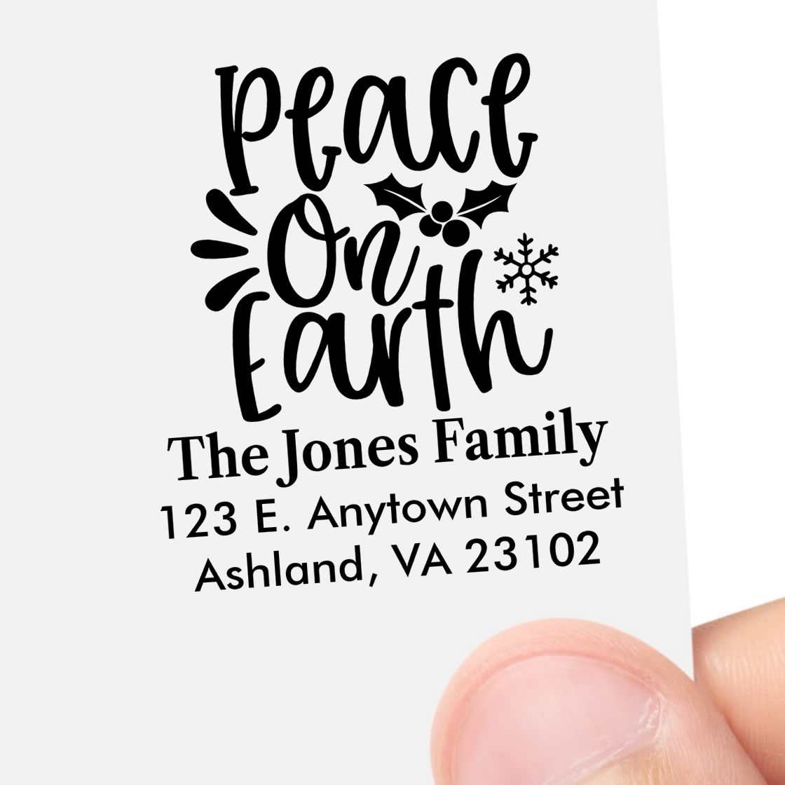 Custom address rubber stamp with Peace On Earth design, family name, and mailing address for Christmas cards.