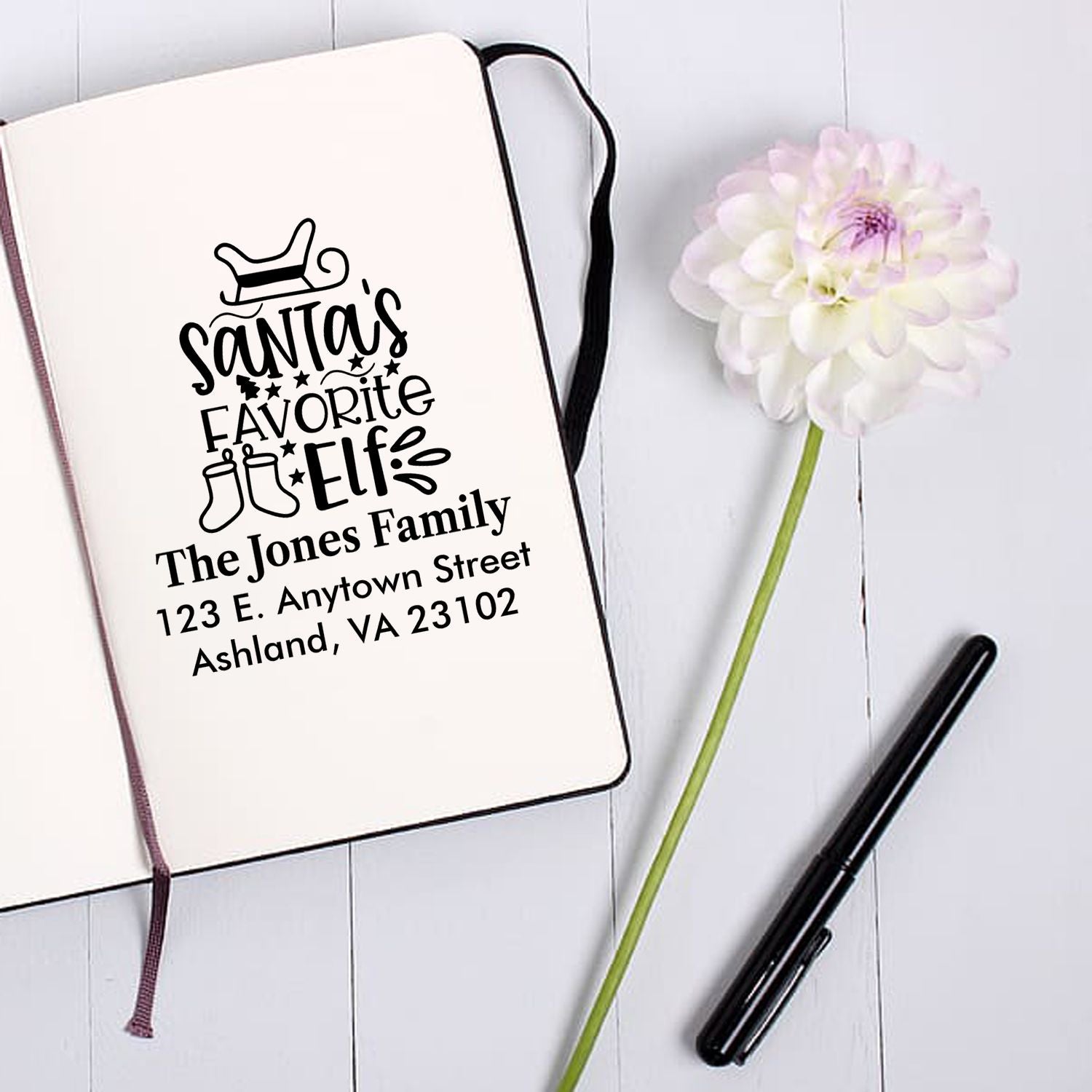 Personalized Santas Favorite Elf rubber stamp with family name and address, perfect for holiday cards and gift tags.